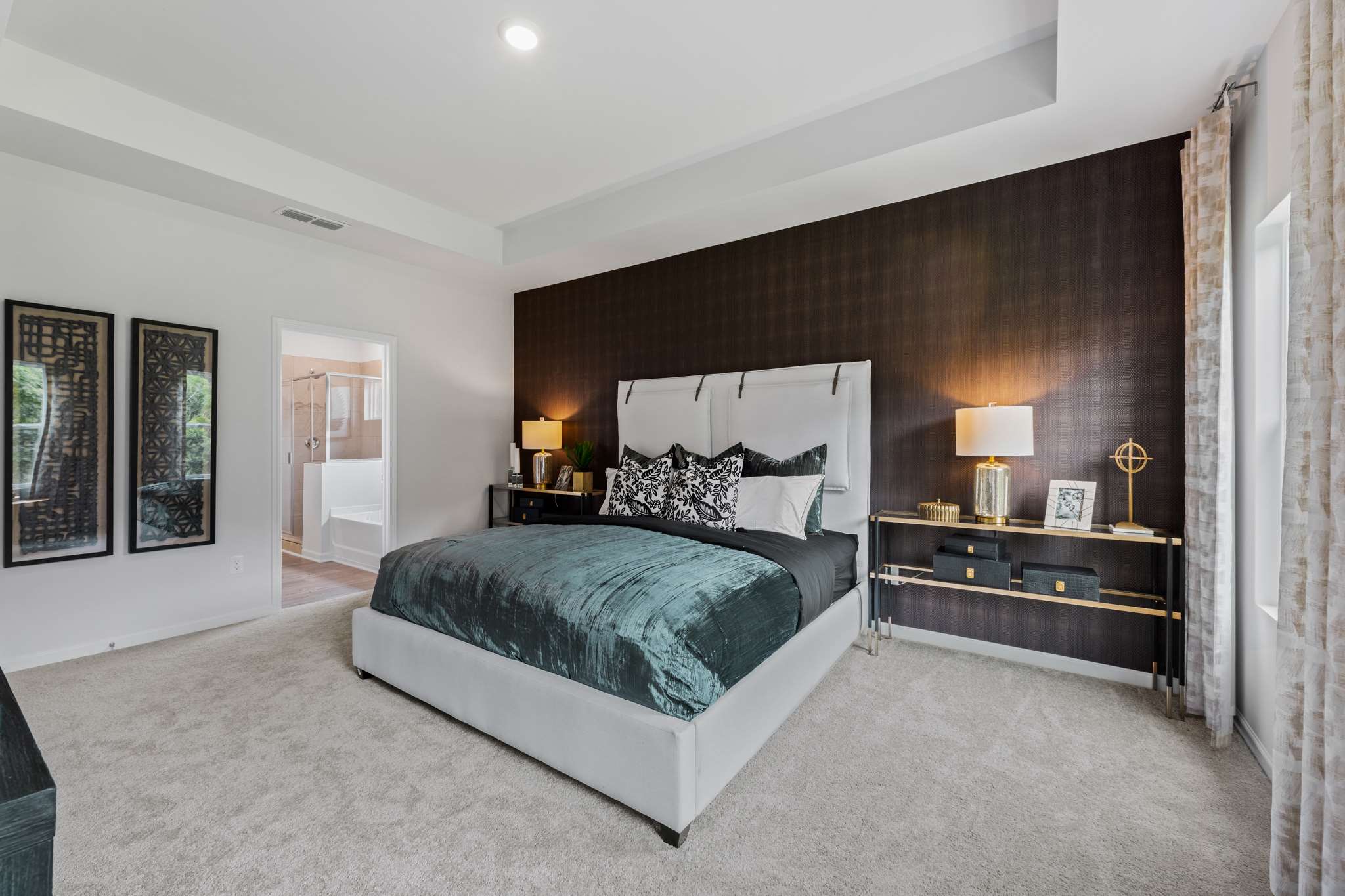 A bedroom with a bed and lamps.