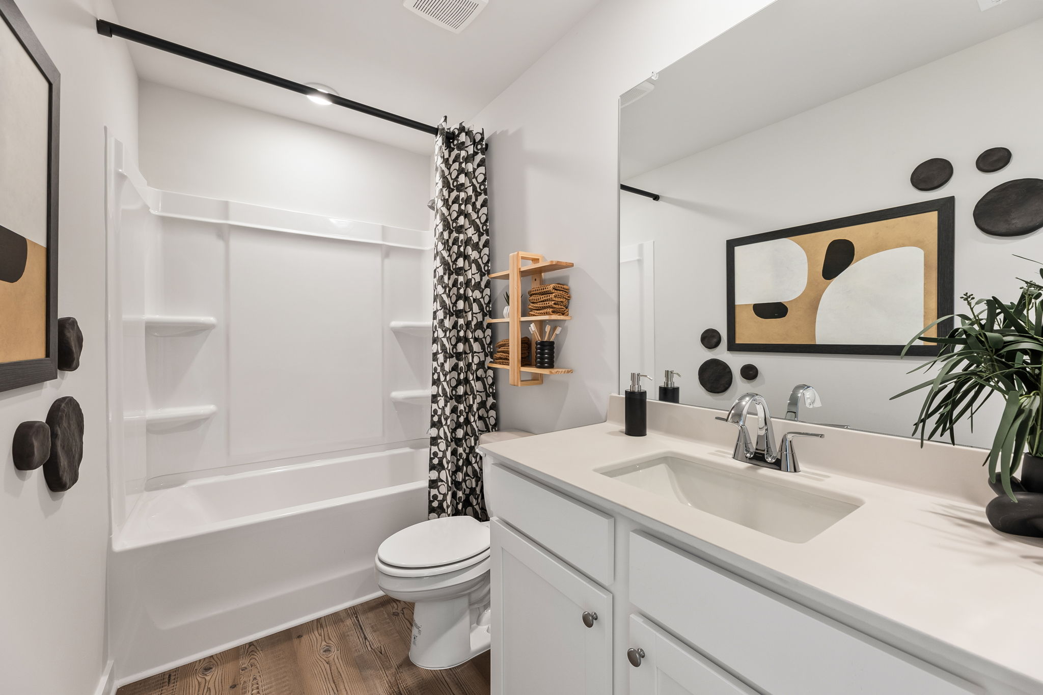 A bathroom with a tub sink and toilet.