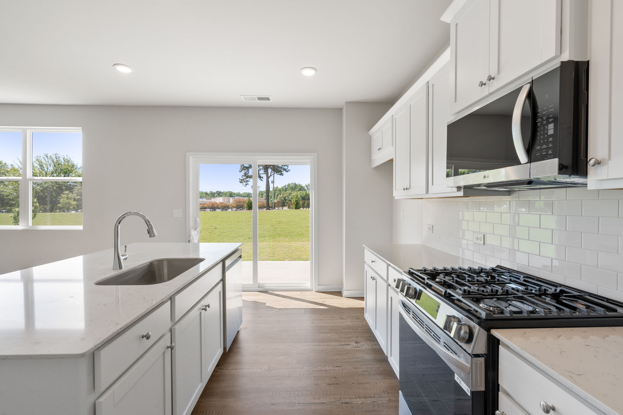 A kitchen with white cabinets.