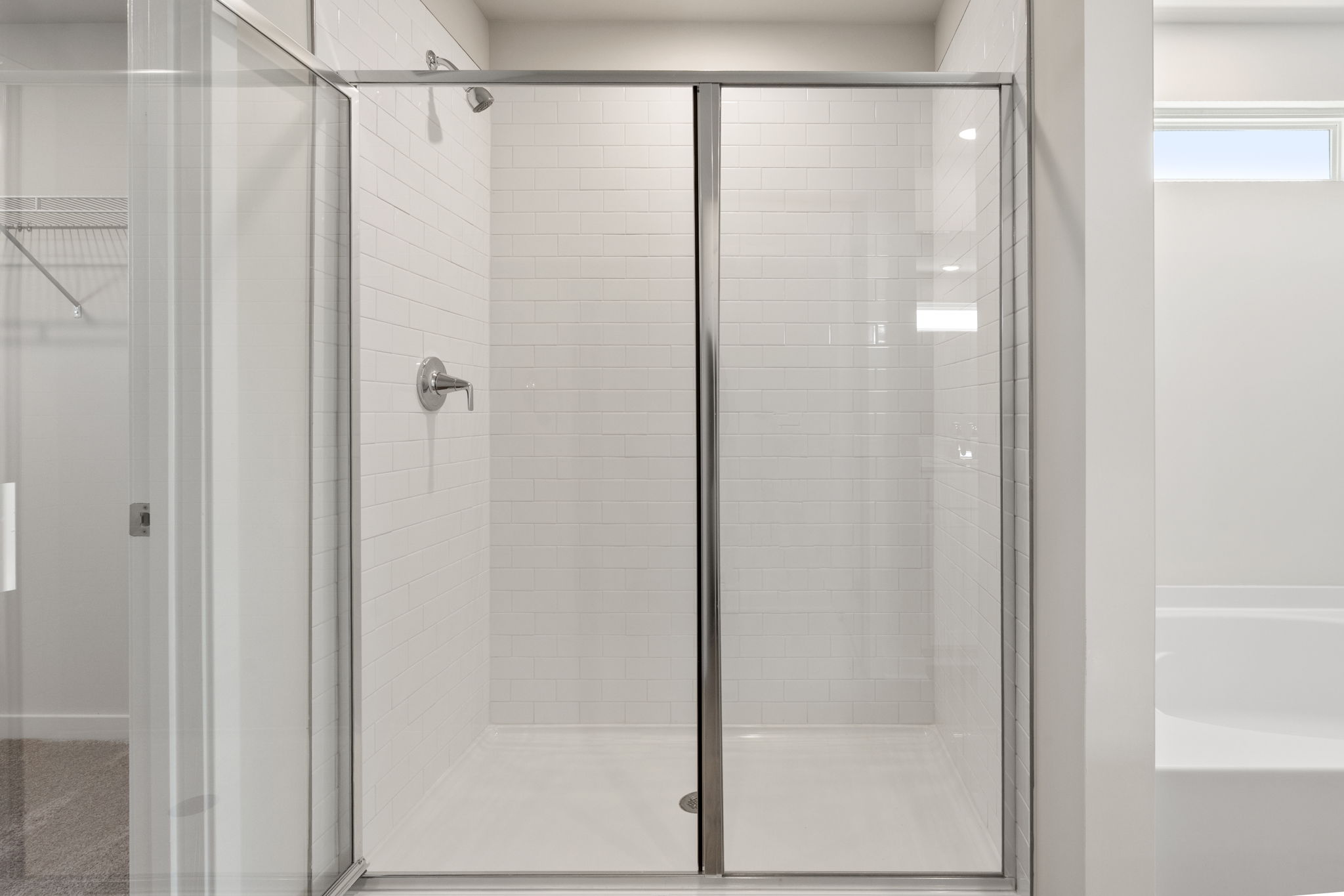 A shower with glass doors.