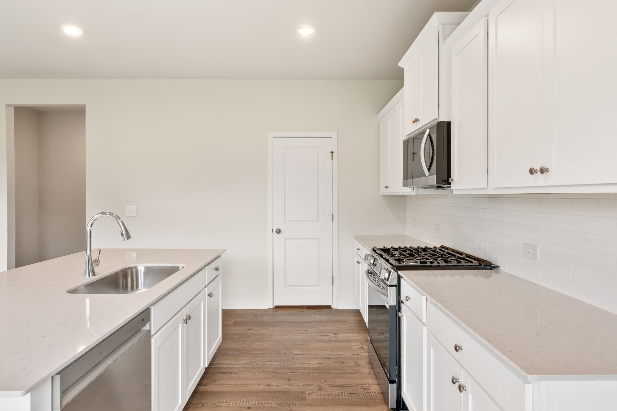 A kitchen with white cabinets.