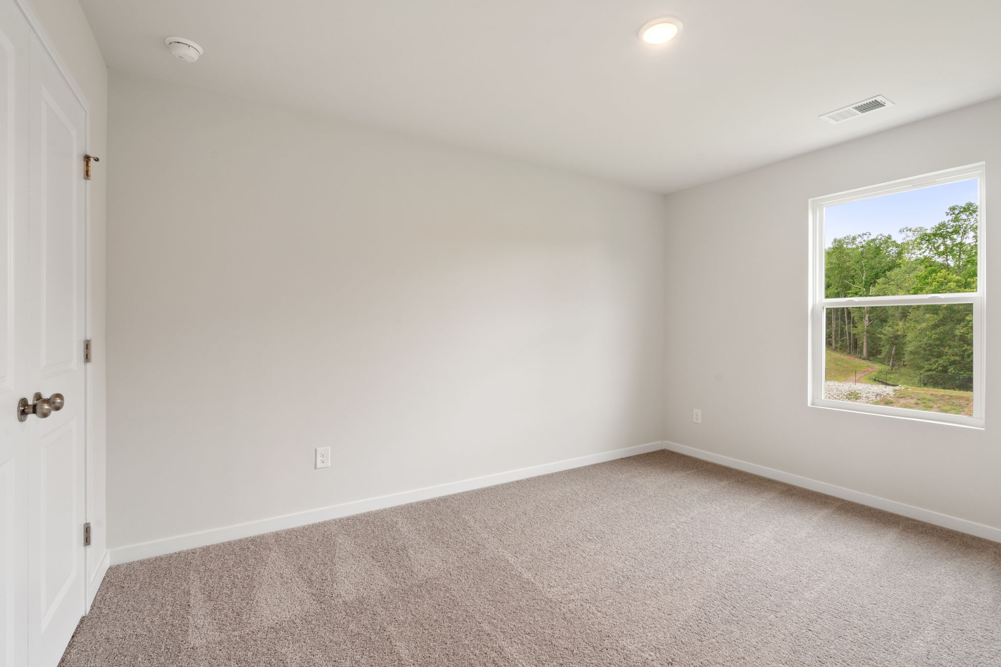 A room with a window and a door.