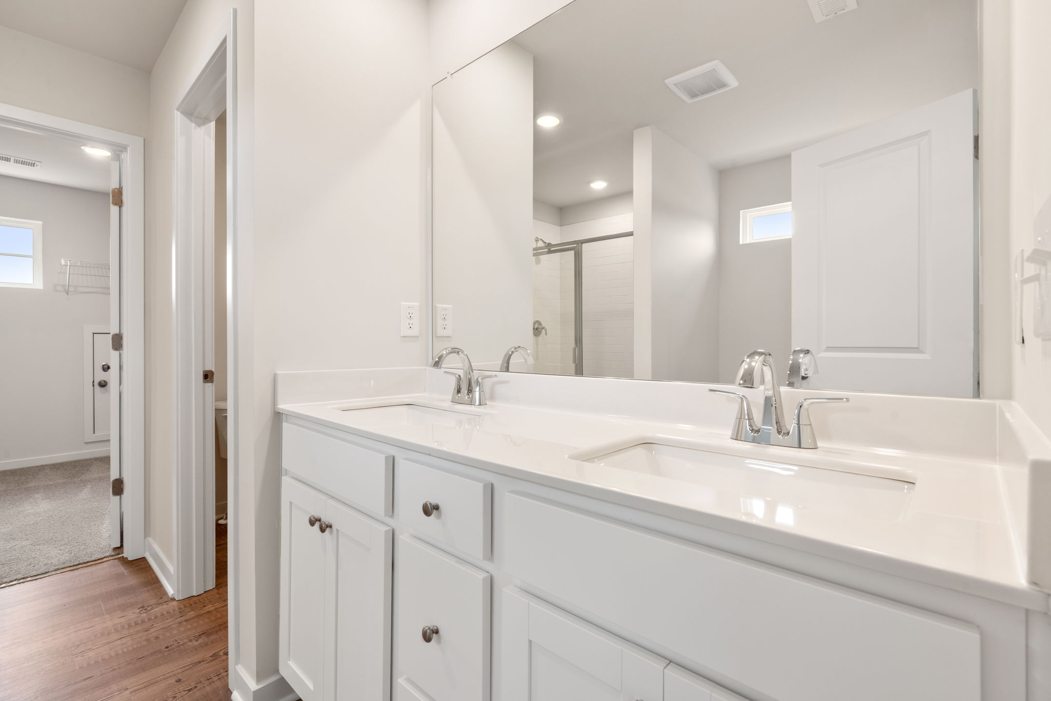 A bathroom with white cabinets.