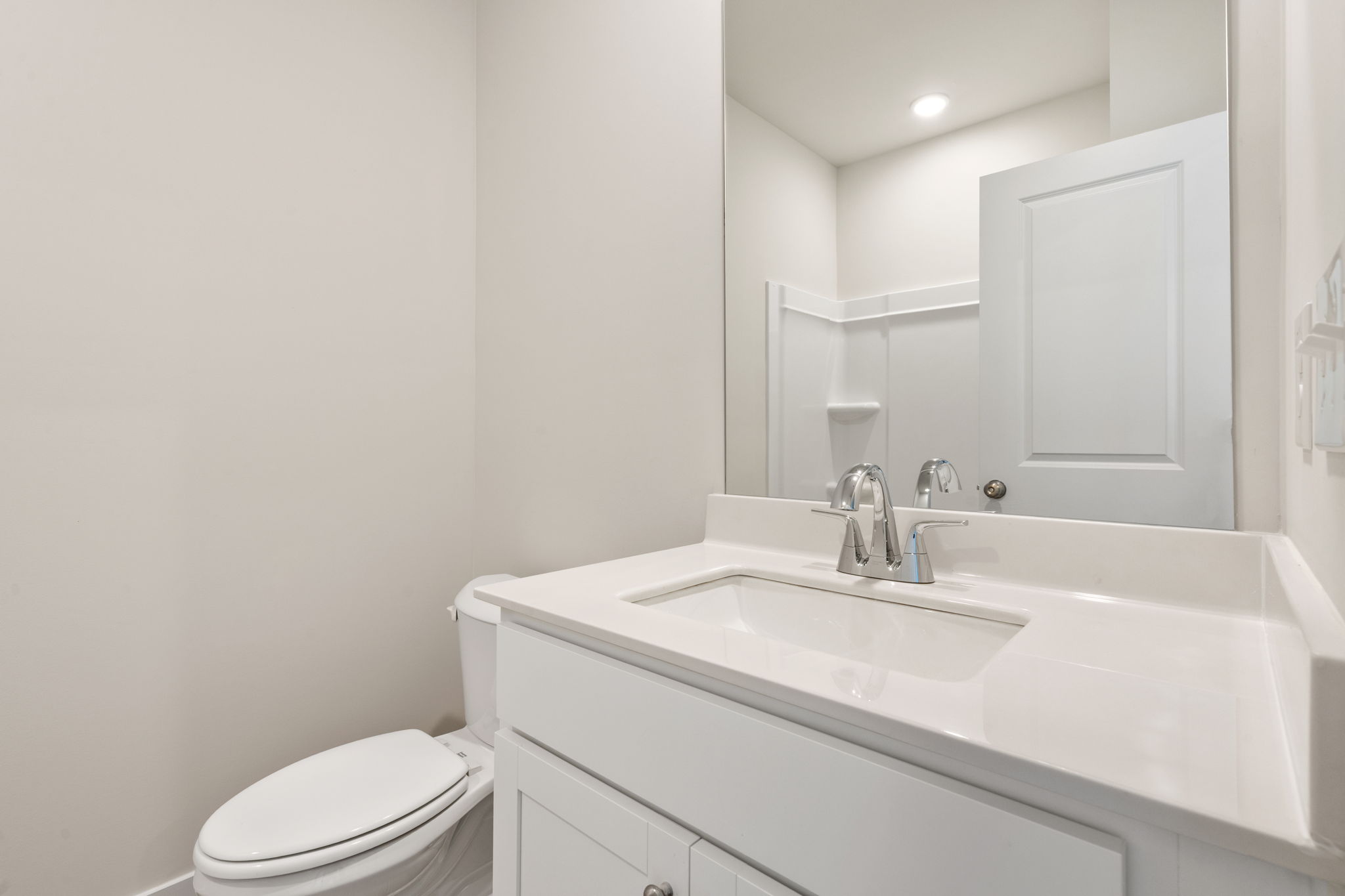 A bathroom with a tub sink and toilet.