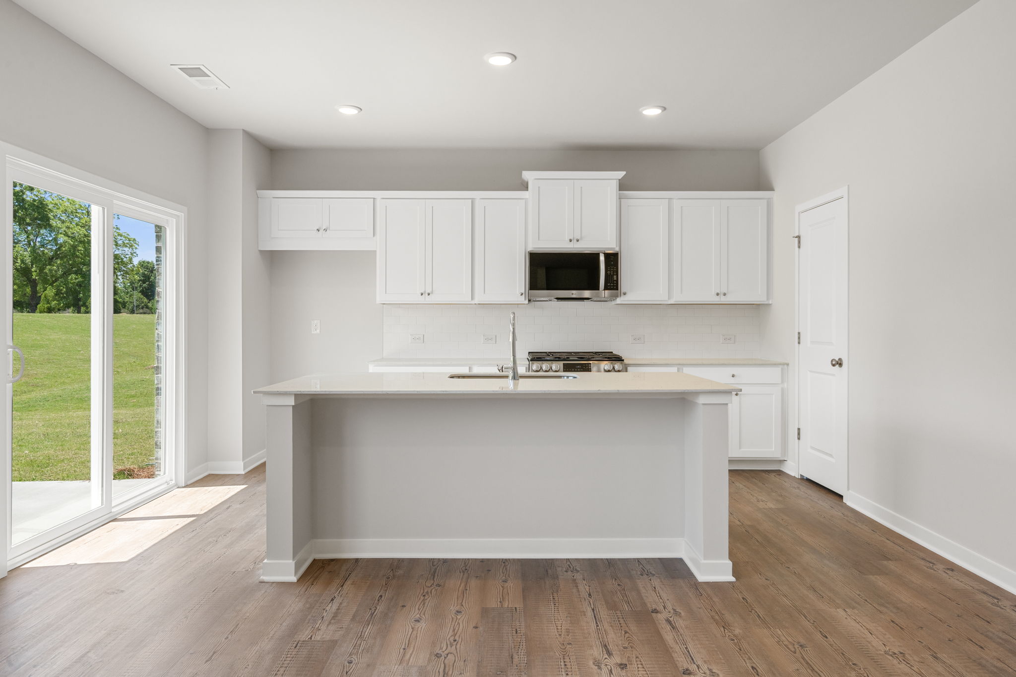 A kitchen with white cabinets.