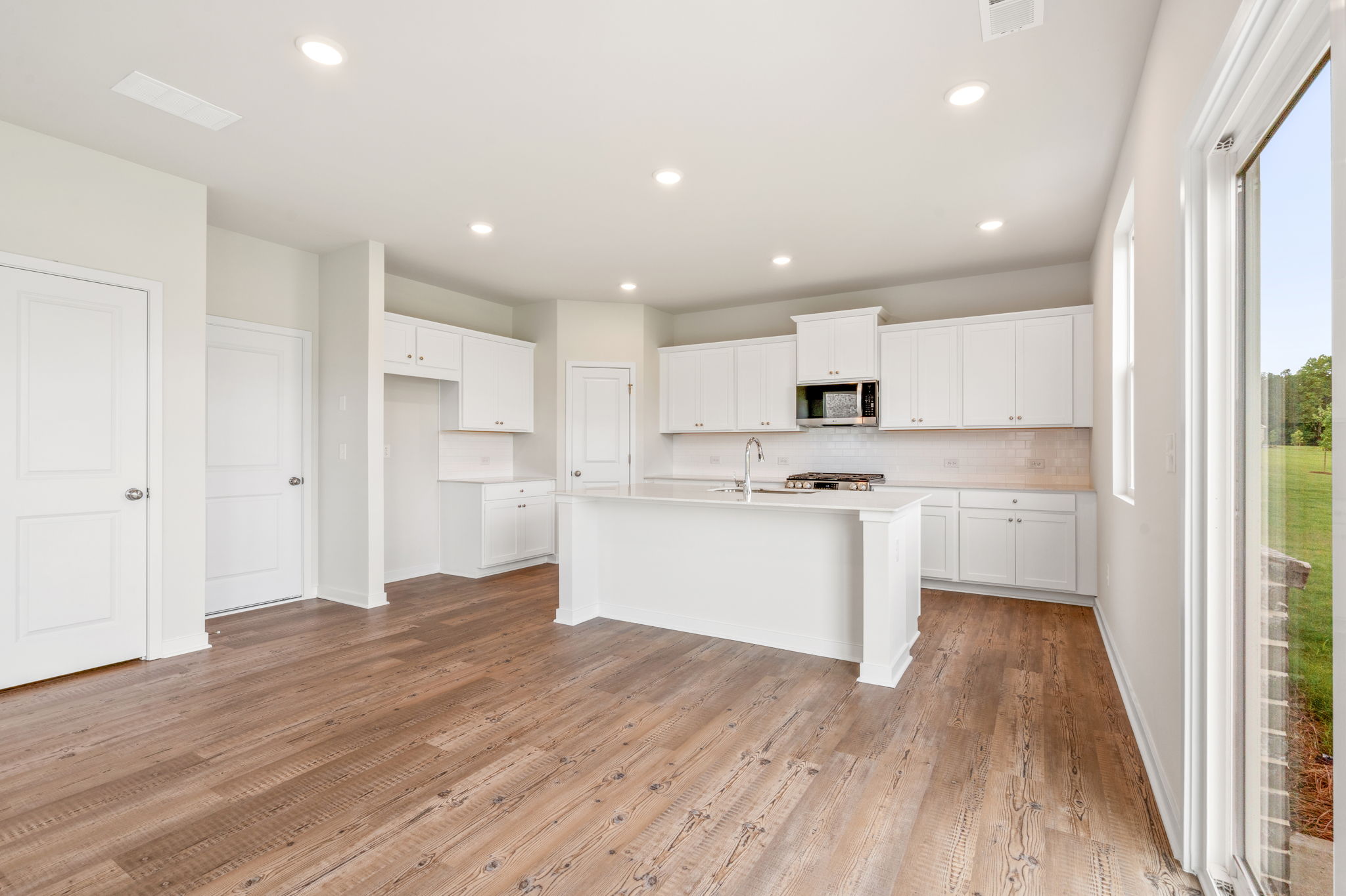 A kitchen with white cabinets.