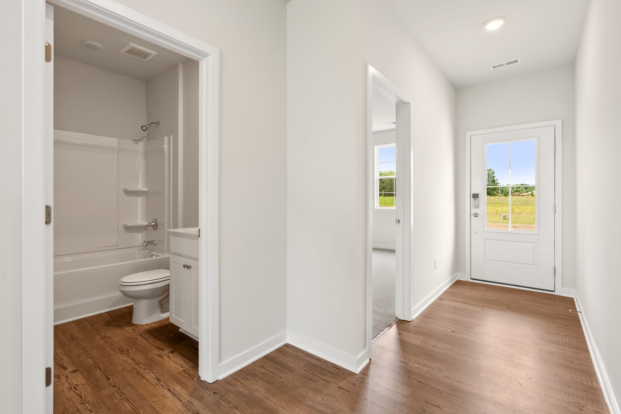 A bathroom with white walls.