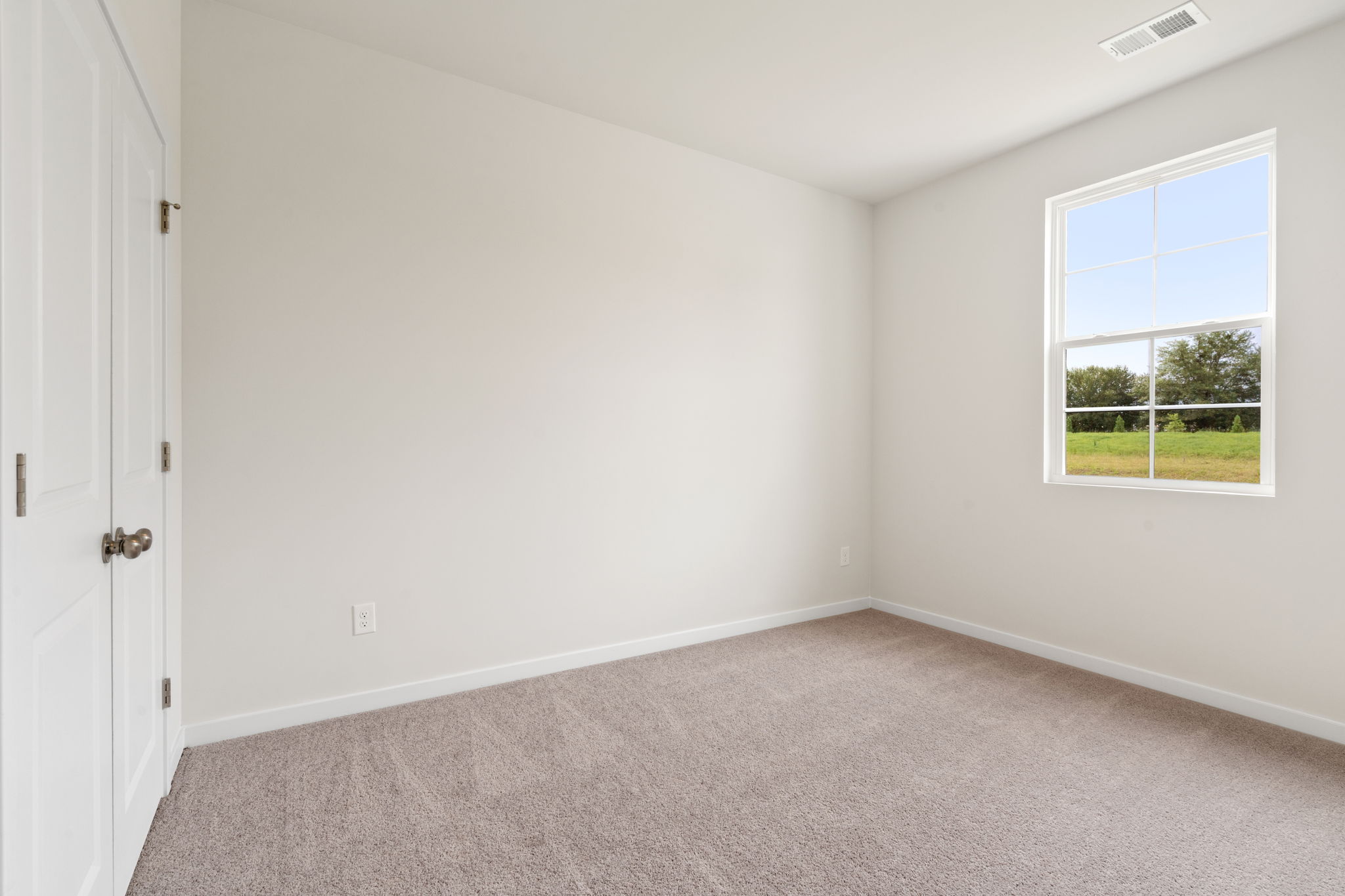 A room with a window and a door.