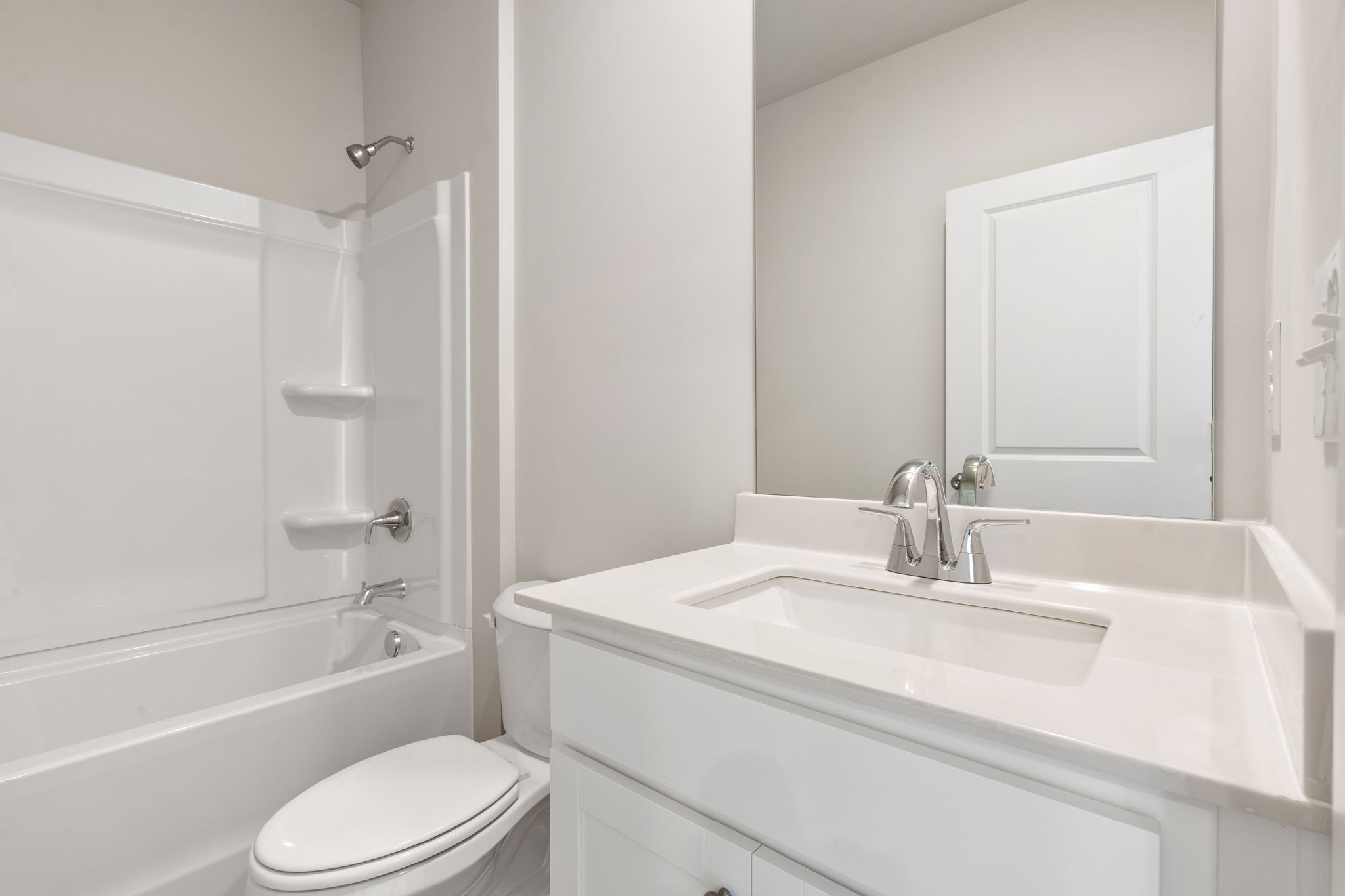 A bathroom with a sink toilet and bathtub.