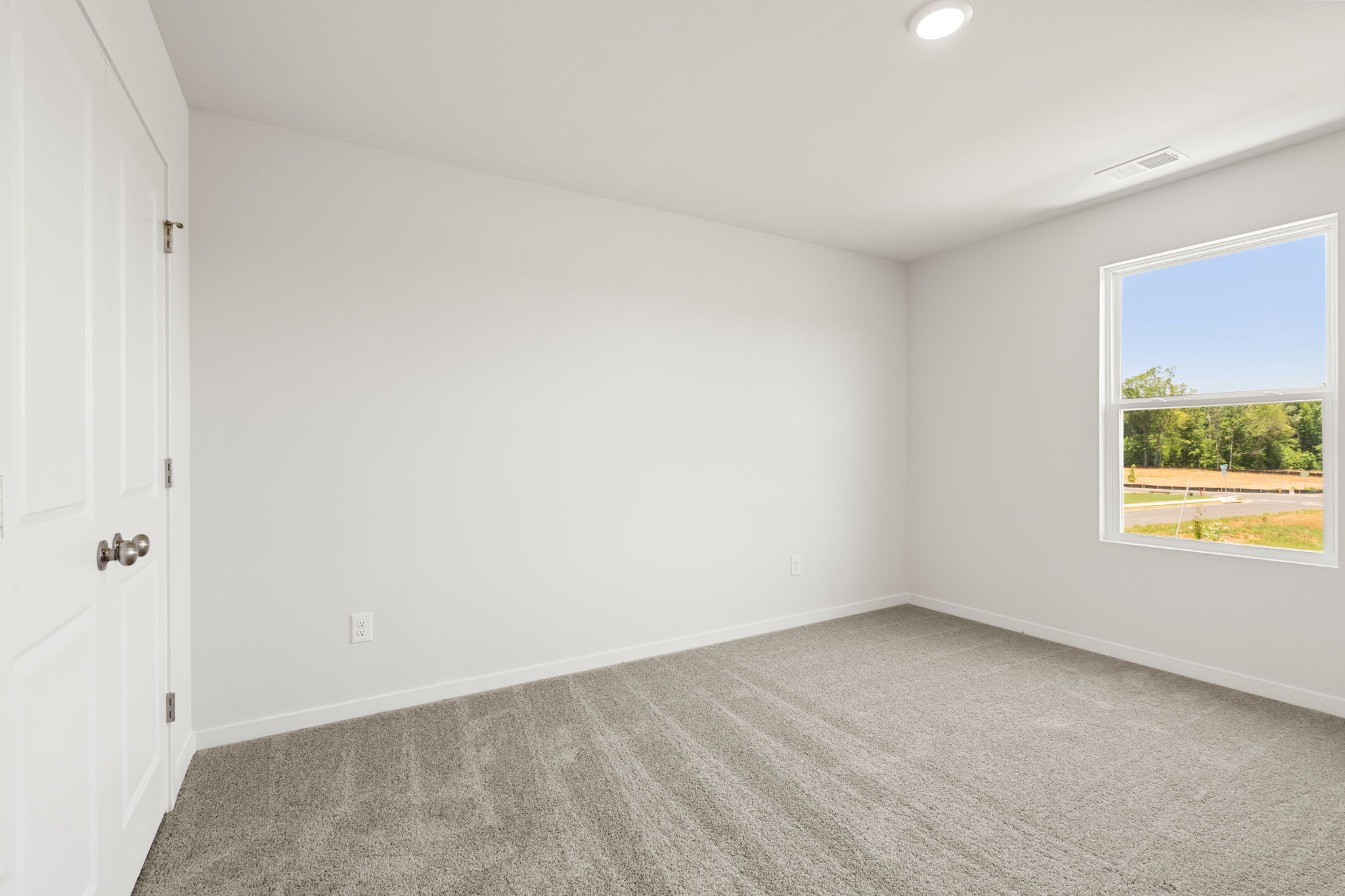 A room with a window and a door.