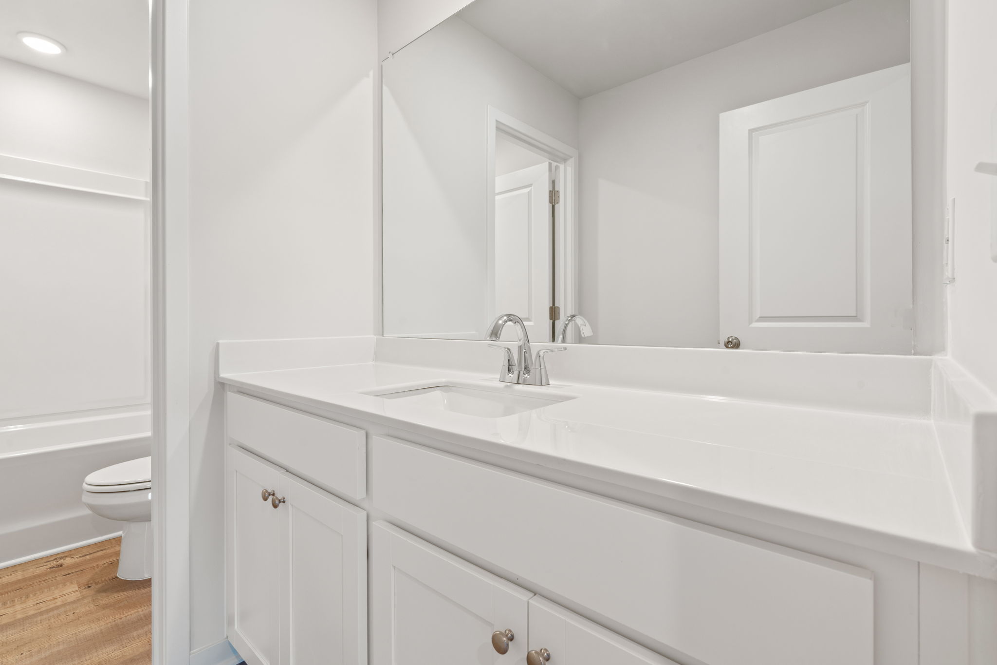 A bathroom with a sink and a toilet.