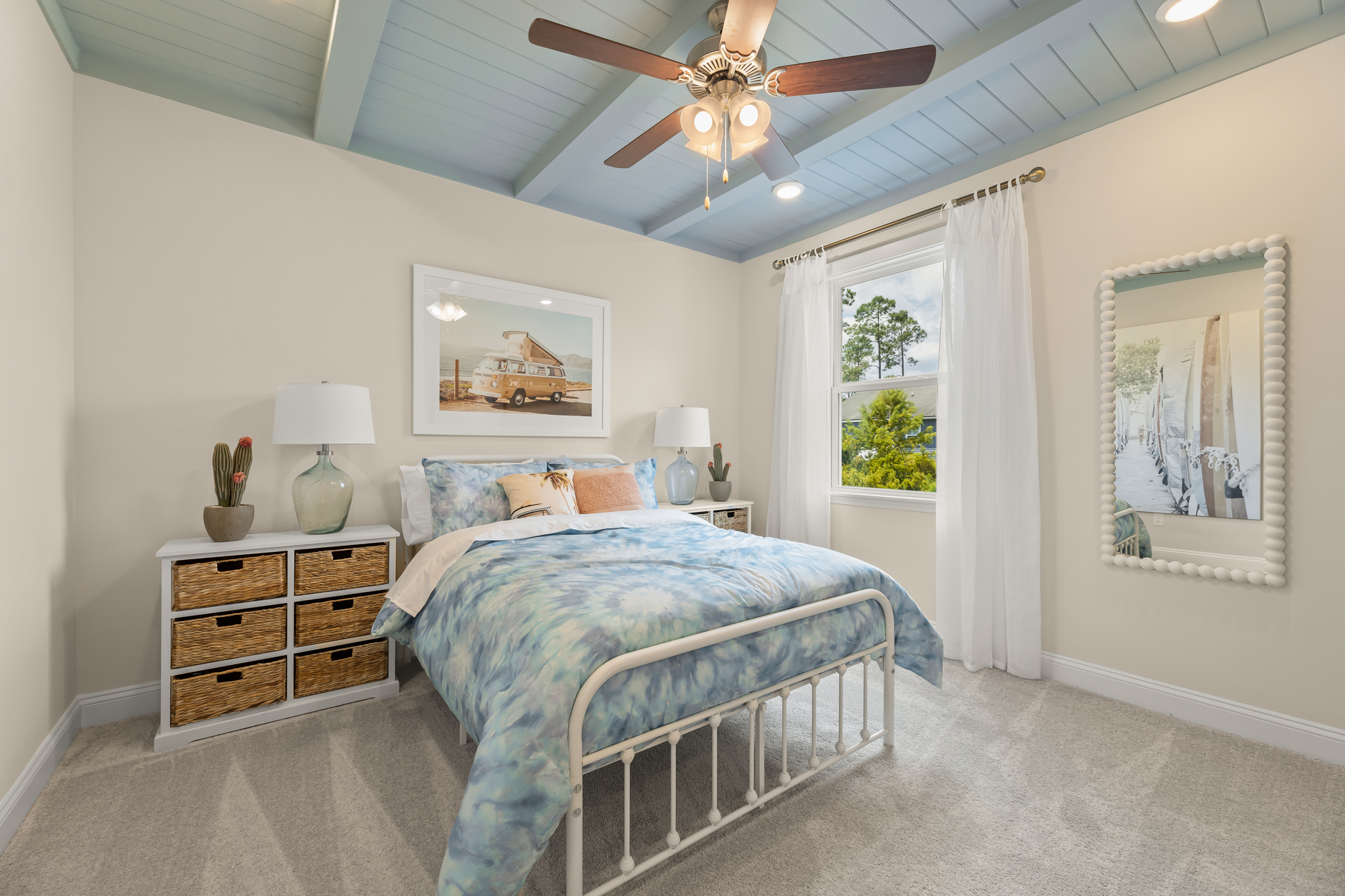 A bedroom with a bed and a fan.