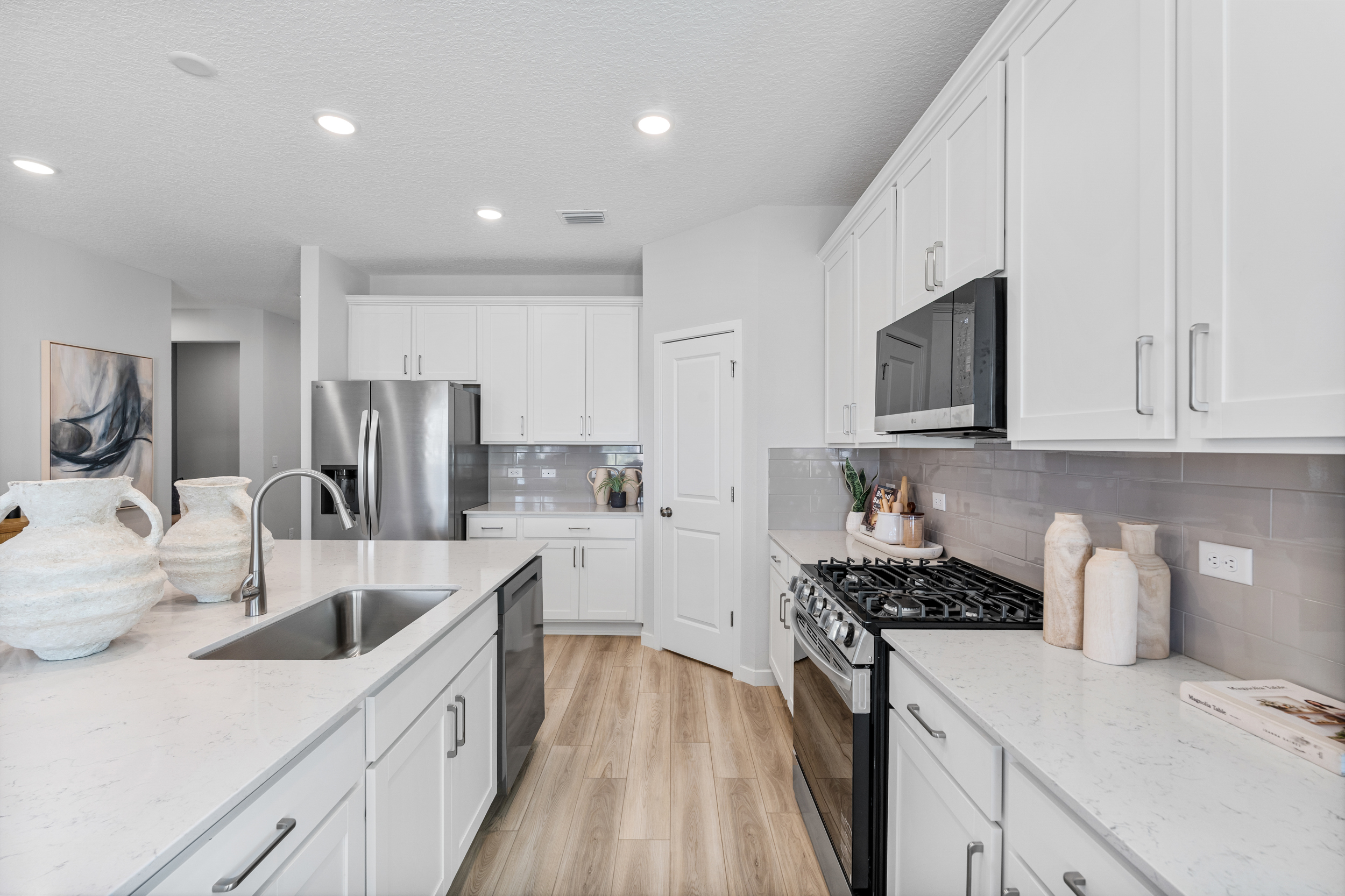Coronado Model Home Kitchen with Walk-In Corner Pantry at Reserve East