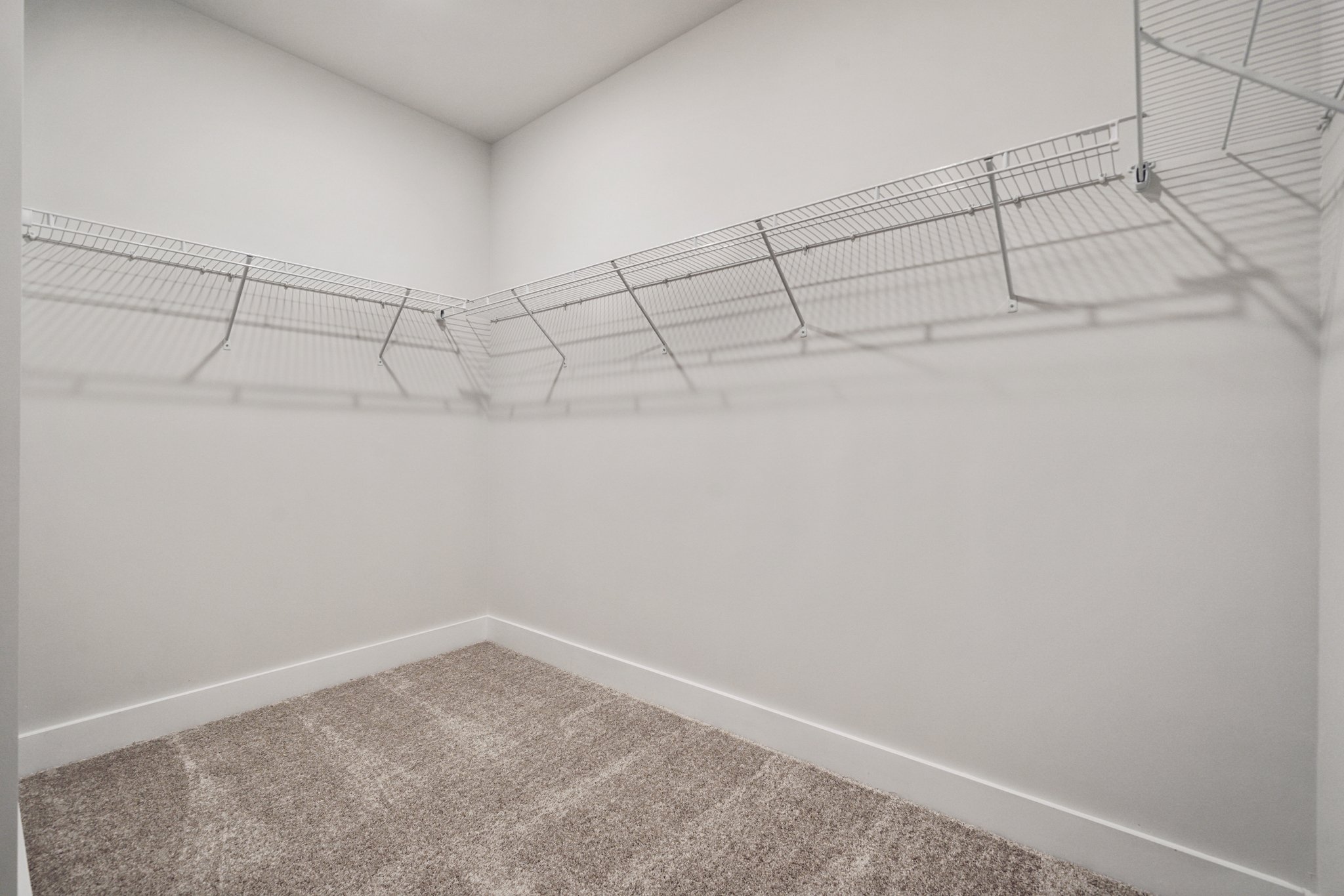 A white wall with a metal railing.