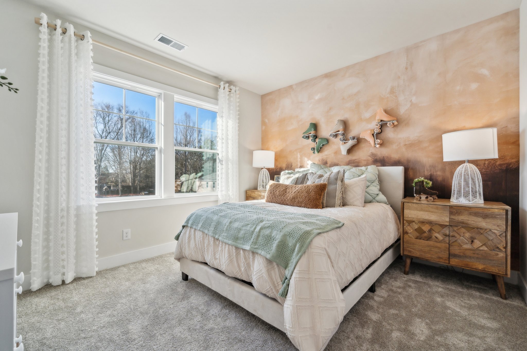 A bedroom with a bed and a dresser.
