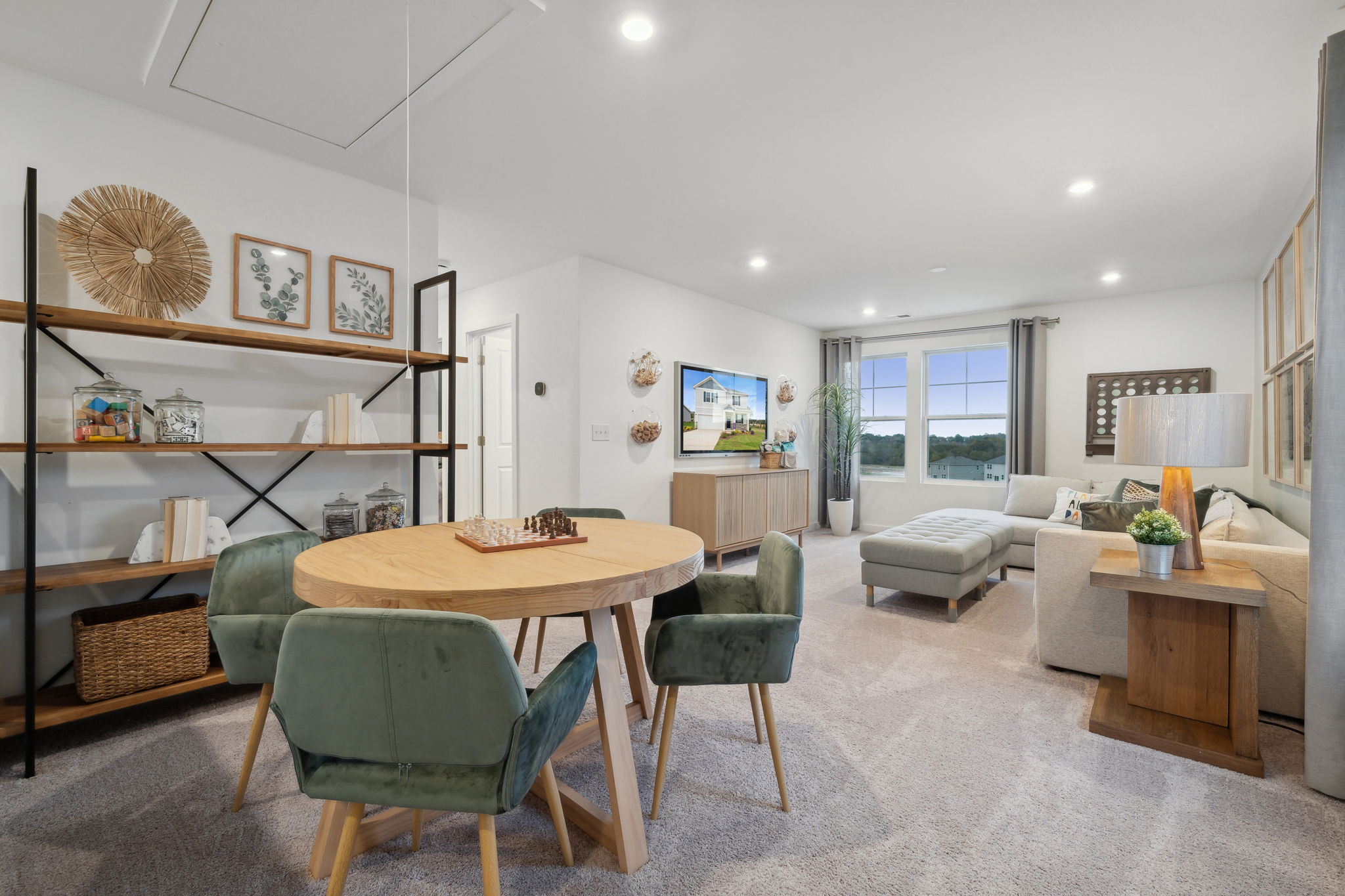 A living room with a table and chairs.