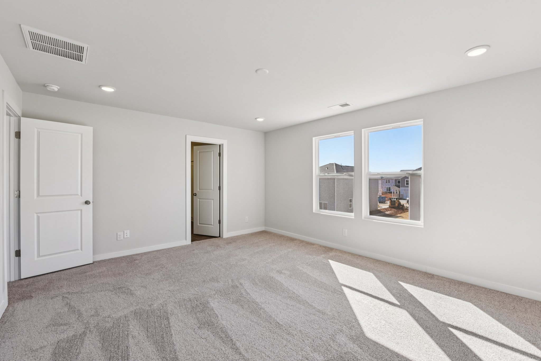 A room with white walls and a rug.