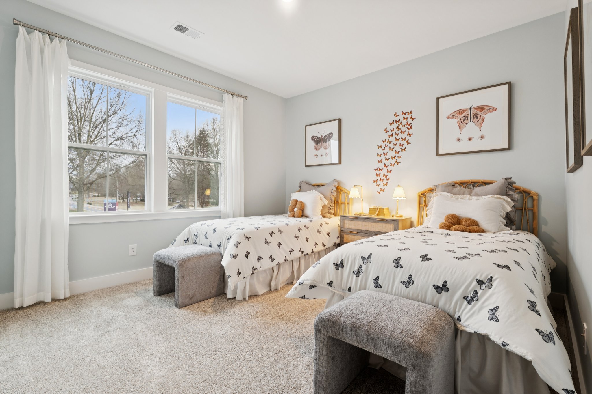 A bedroom with a bed and a chair.