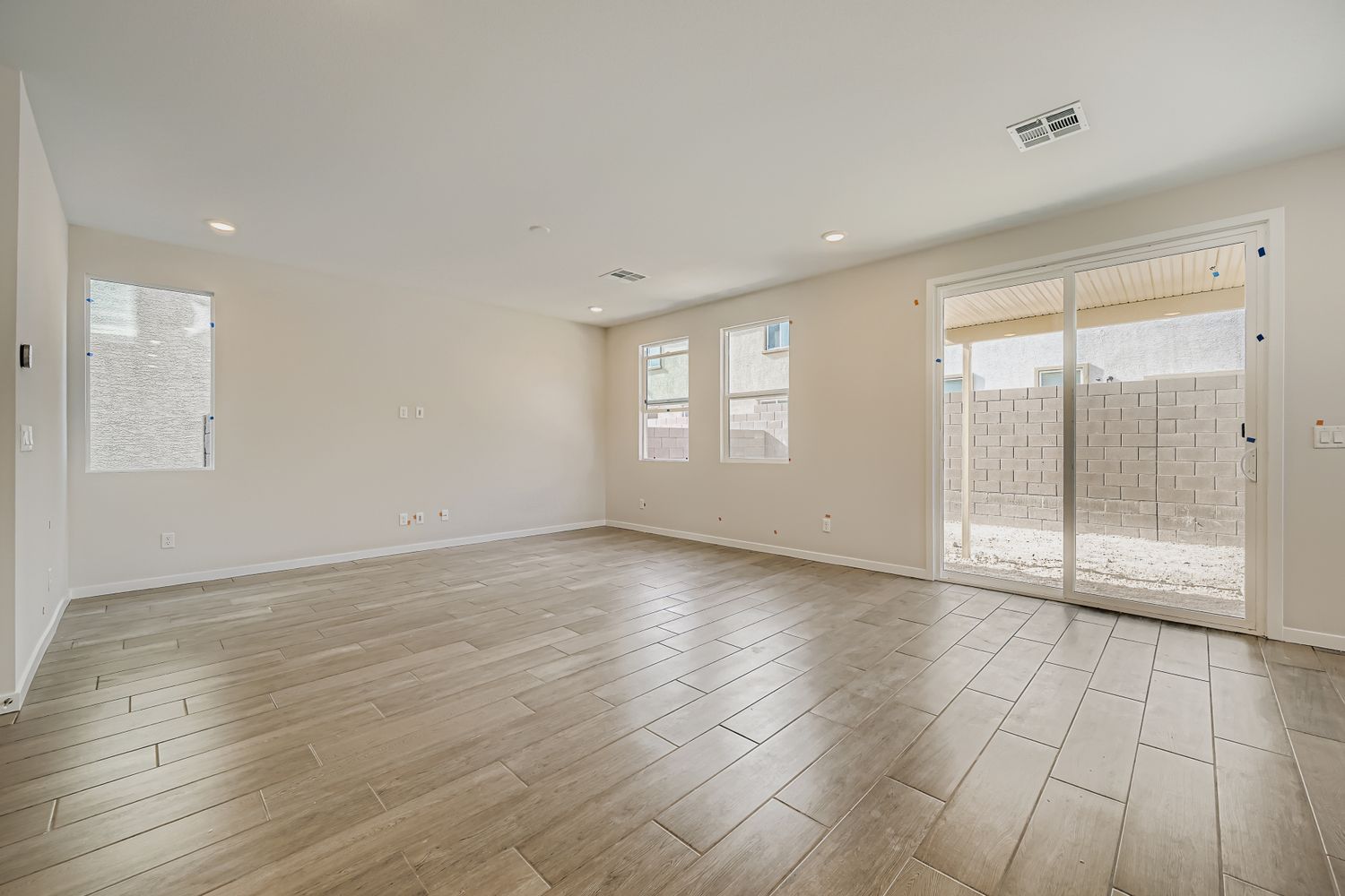 A room with a wood floor and a glass door.