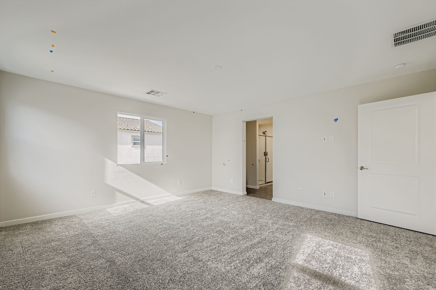 A room with white walls and a carpeted floor.