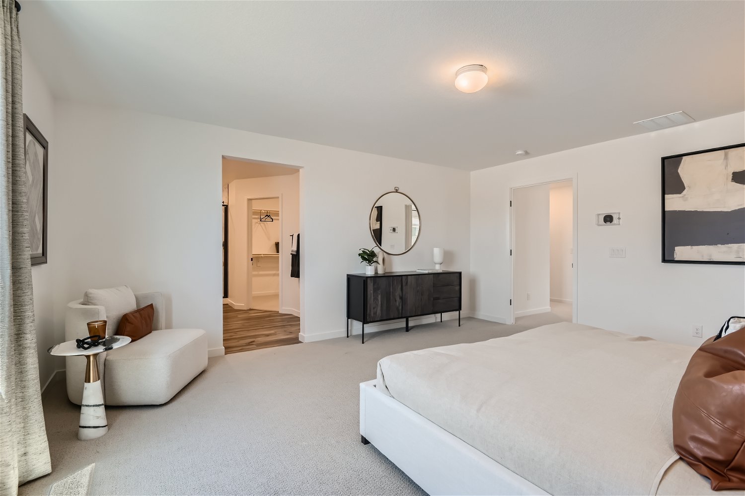 A large bedroom with a large mirror.