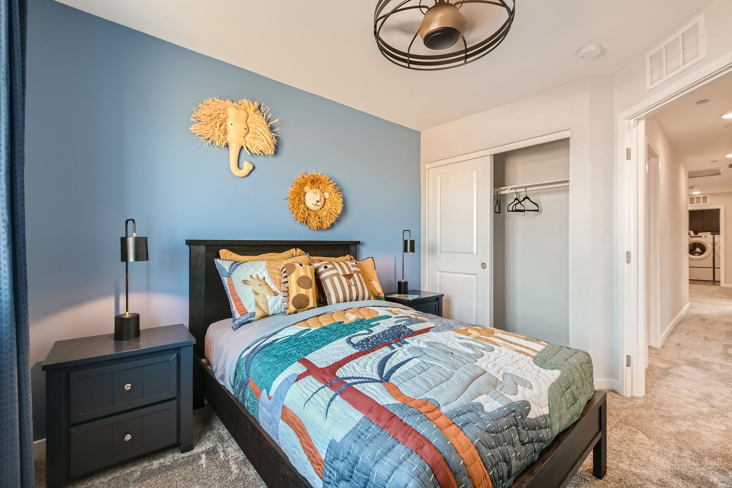 A bedroom with a bed and a lamp.