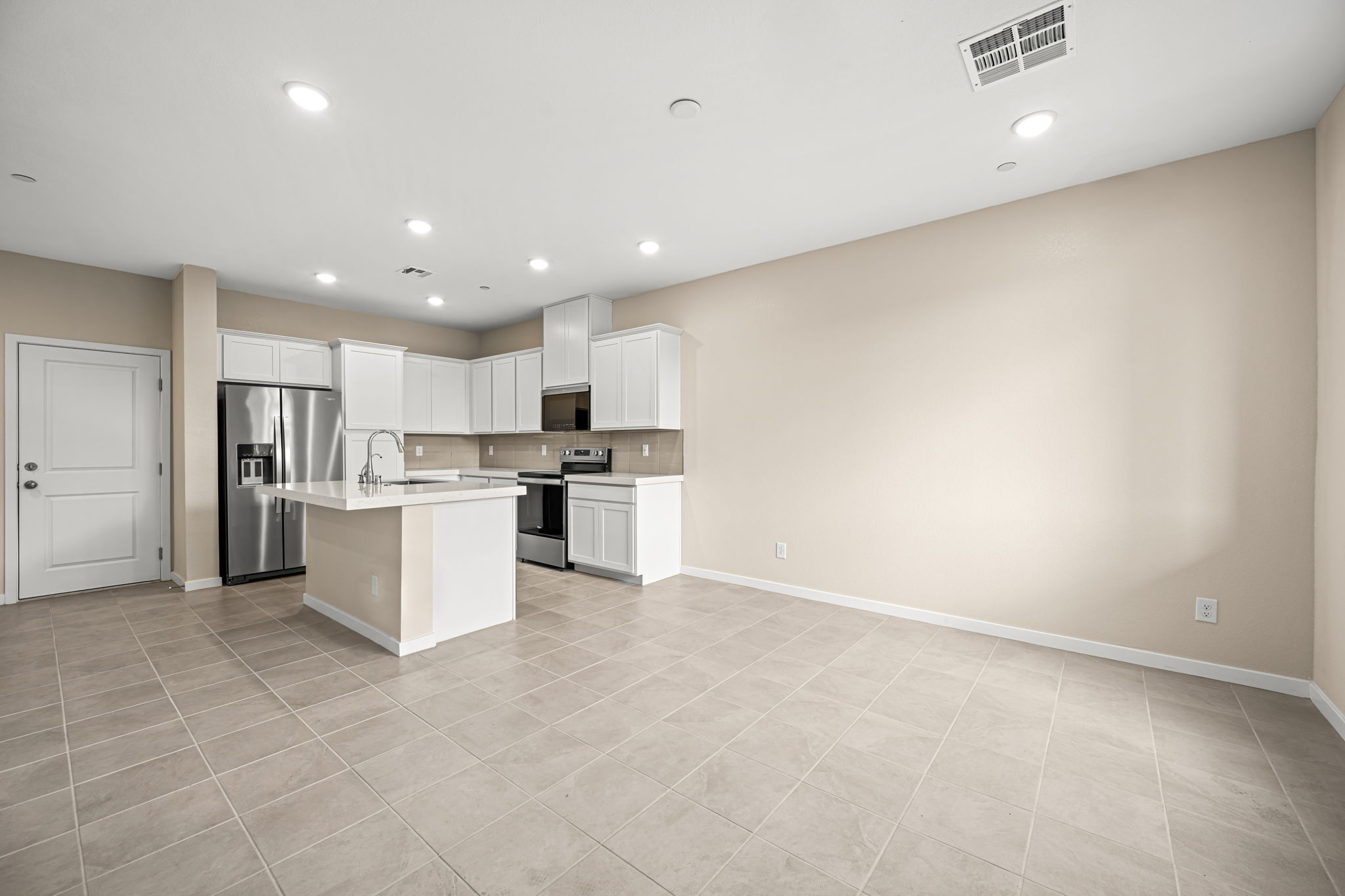 A kitchen with white cabinets.