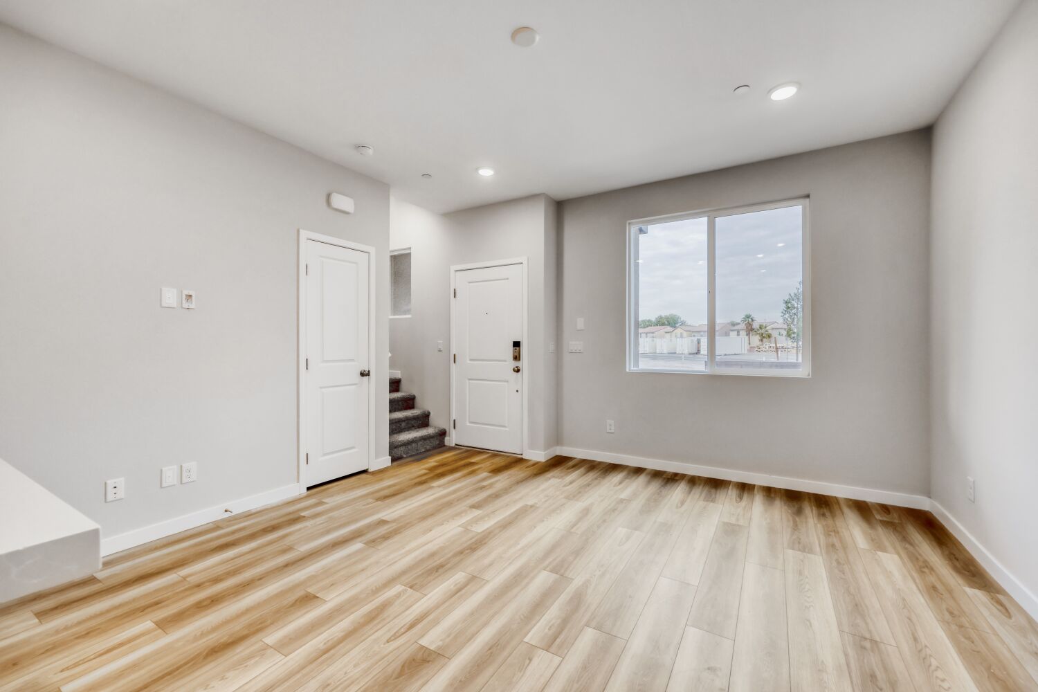A room with a wood floor and white walls.