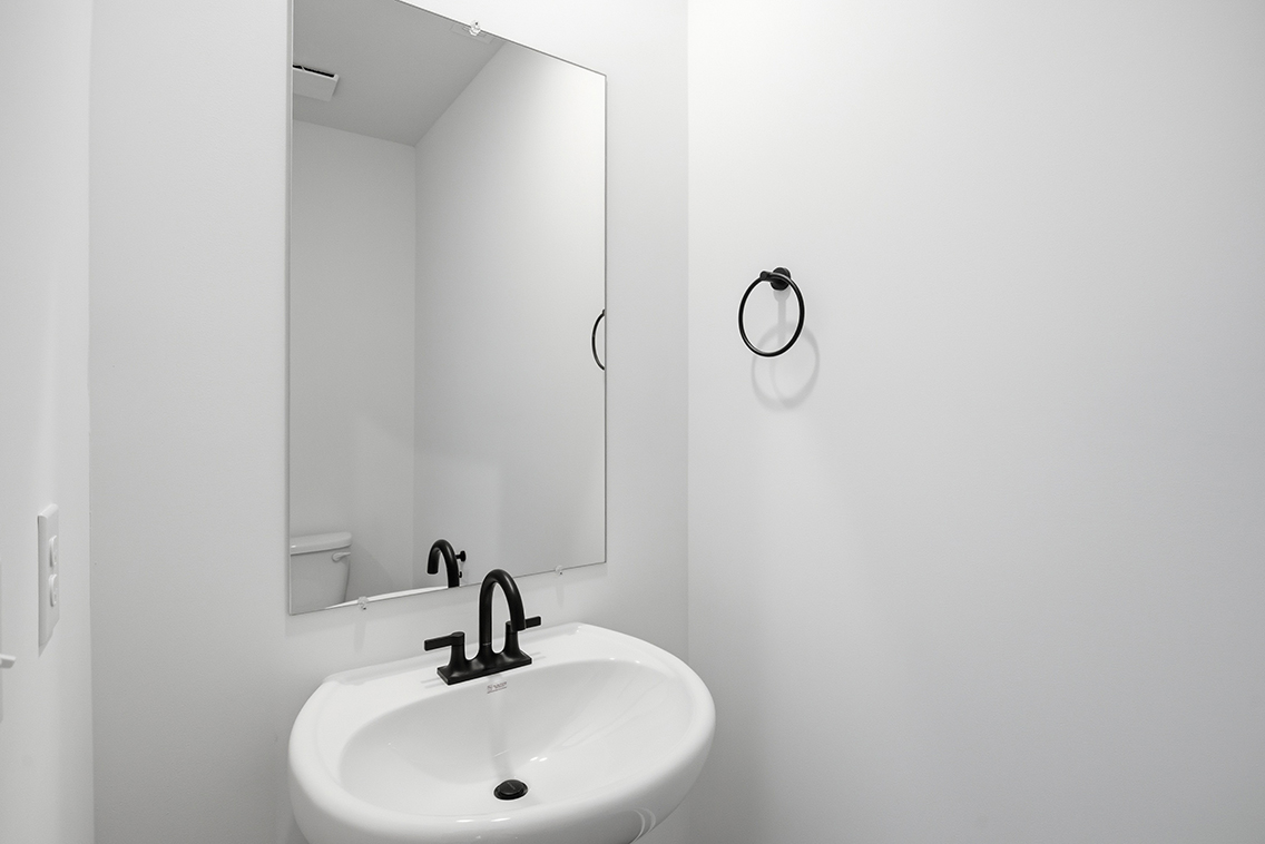 A bathroom with a mirror and sink.