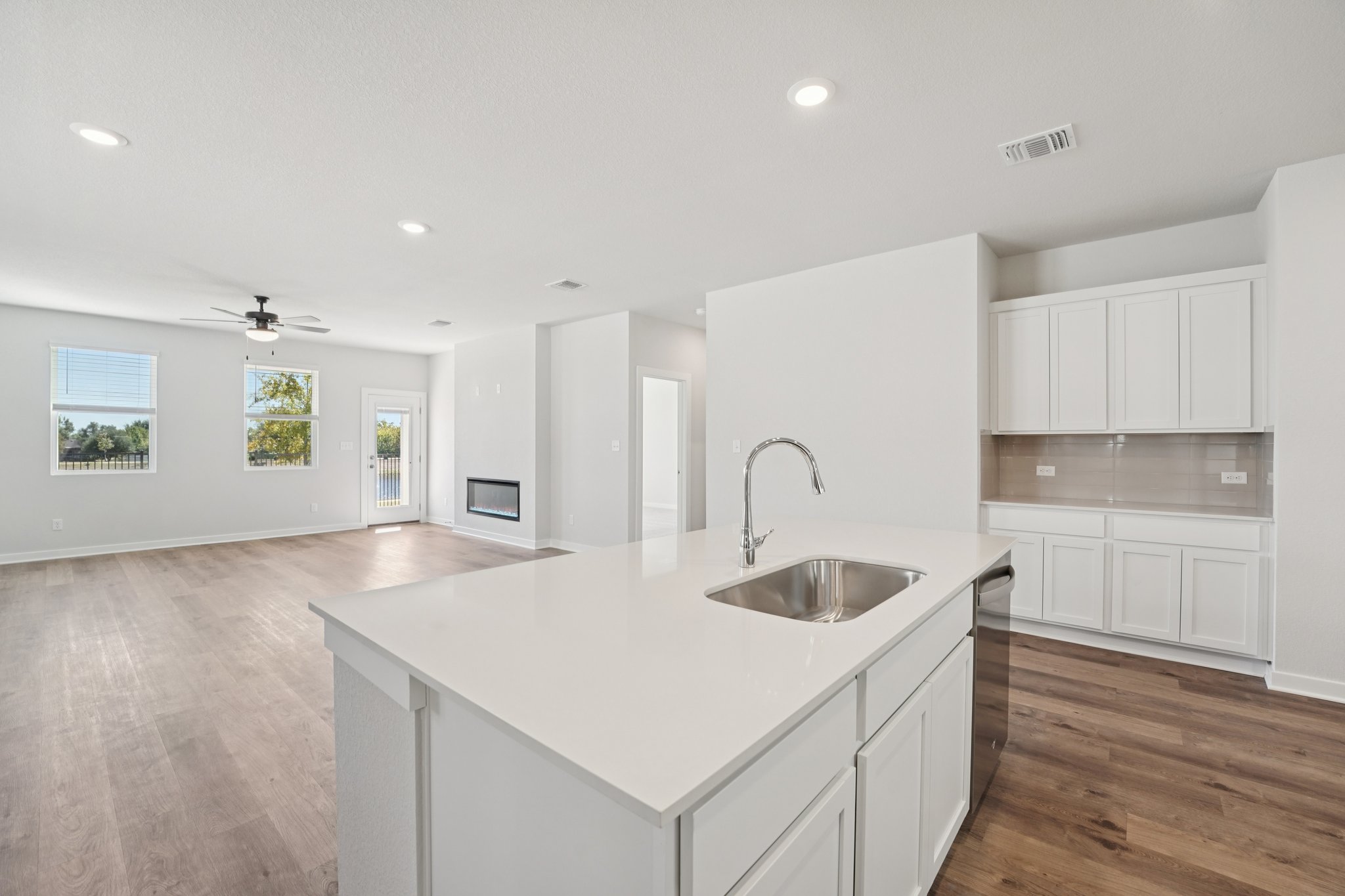 A kitchen with white cabinets.