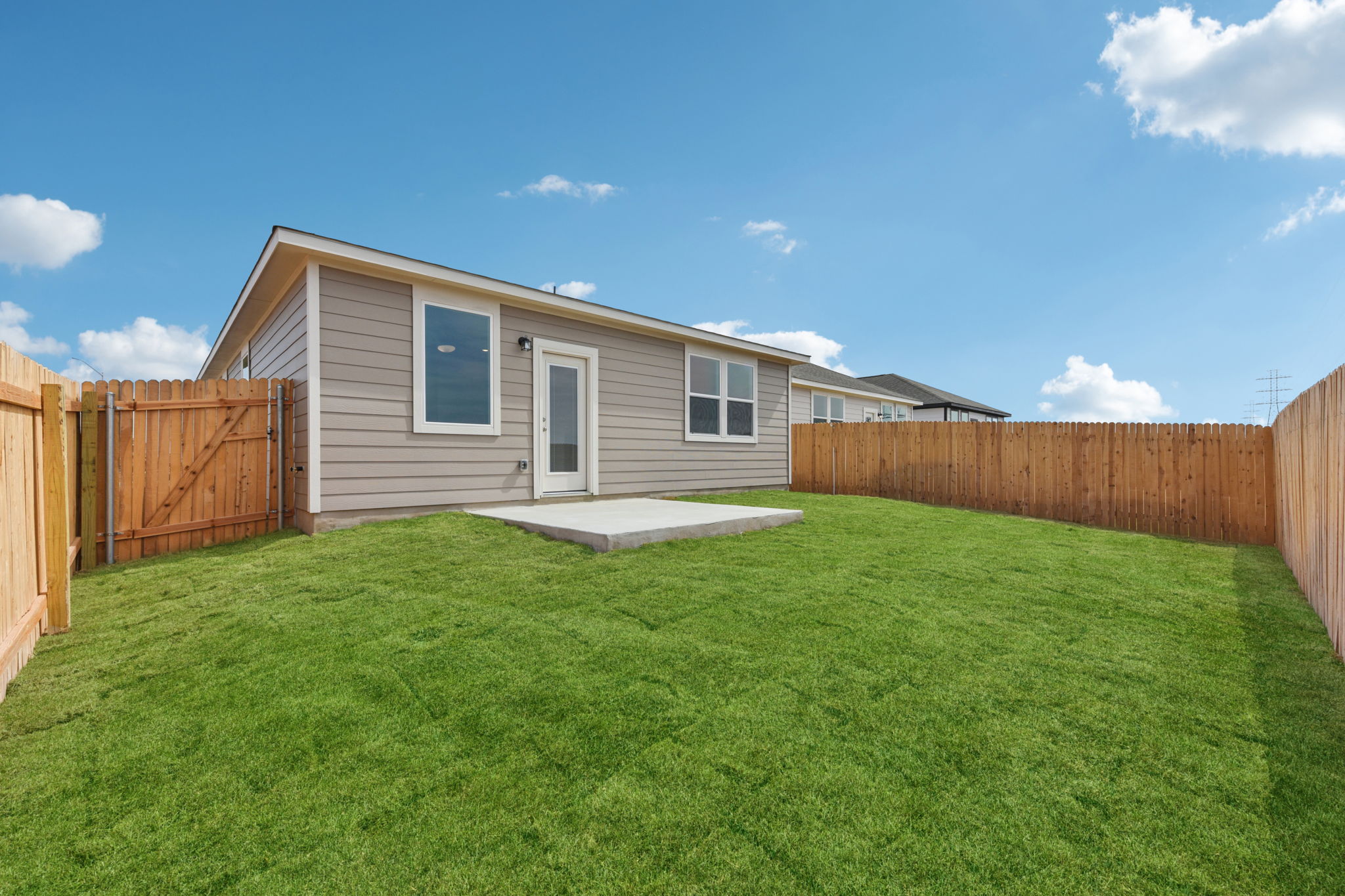 A house with a fence and grass.