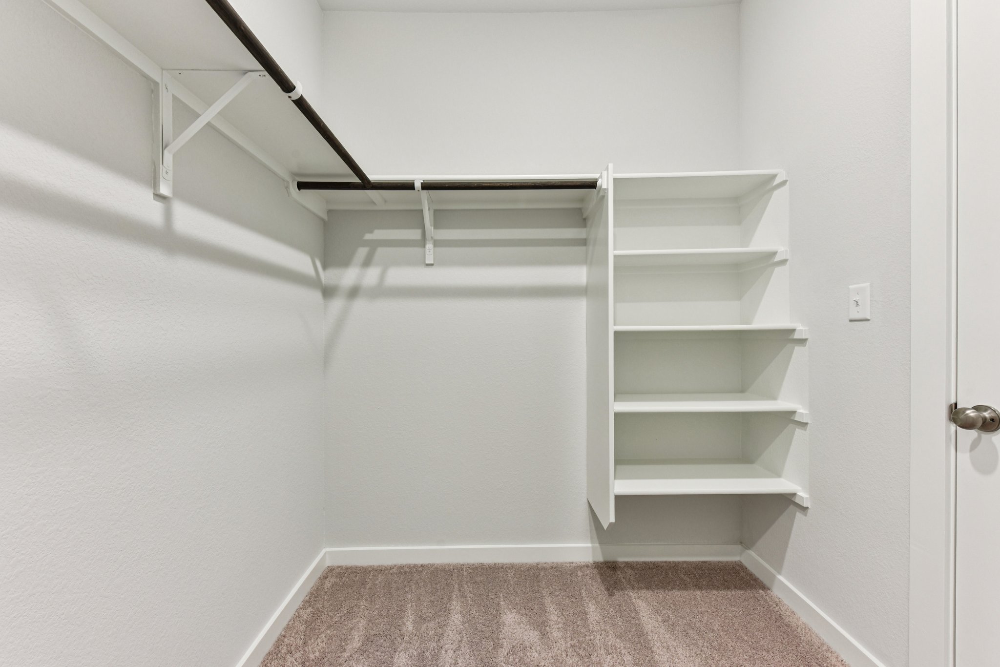 A white staircase in a room.