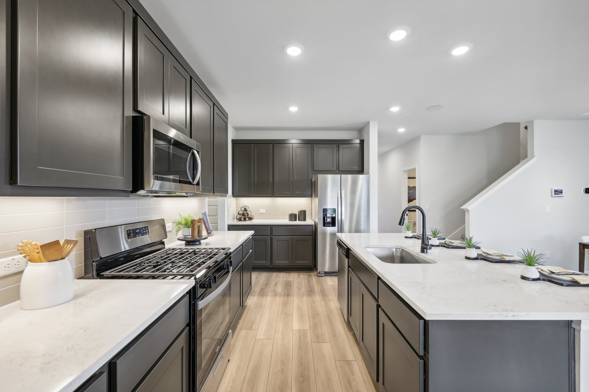 A kitchen with black cabinets.