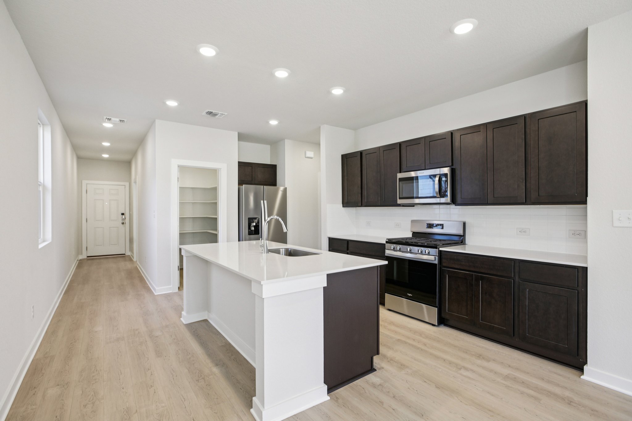 A kitchen with black cabinets.
