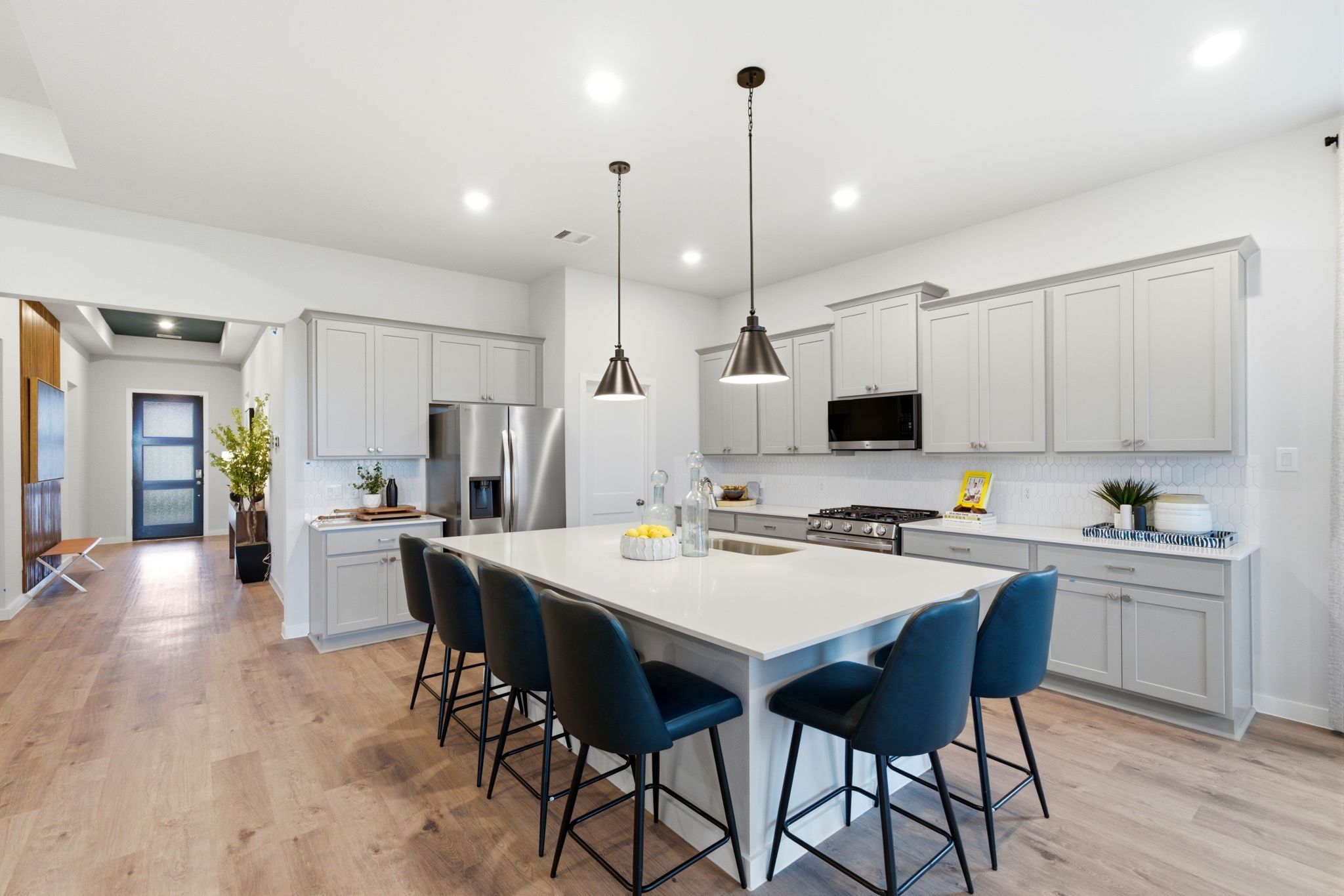 A kitchen with a dining table and chairs.