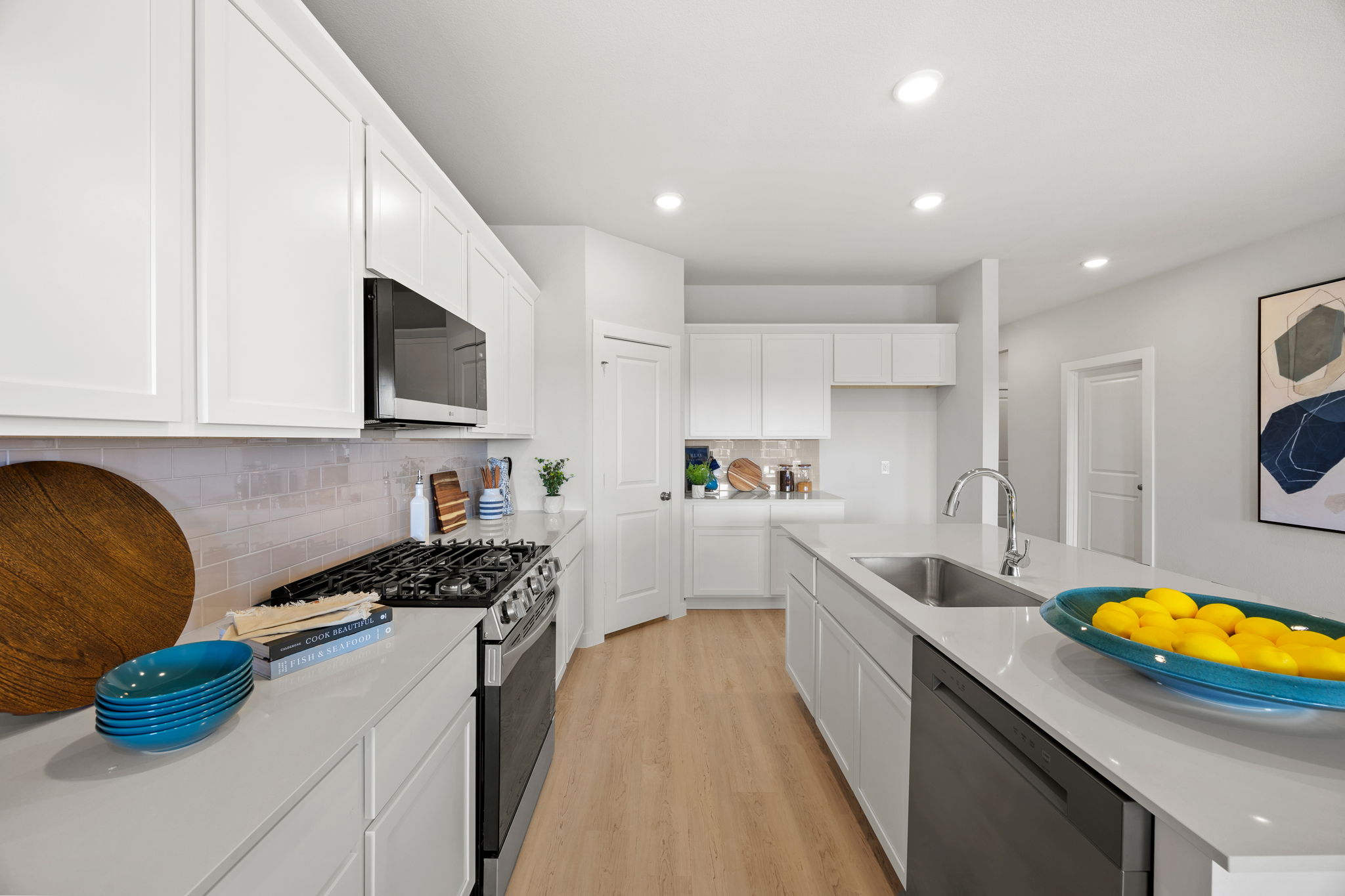 A kitchen with white cabinets.