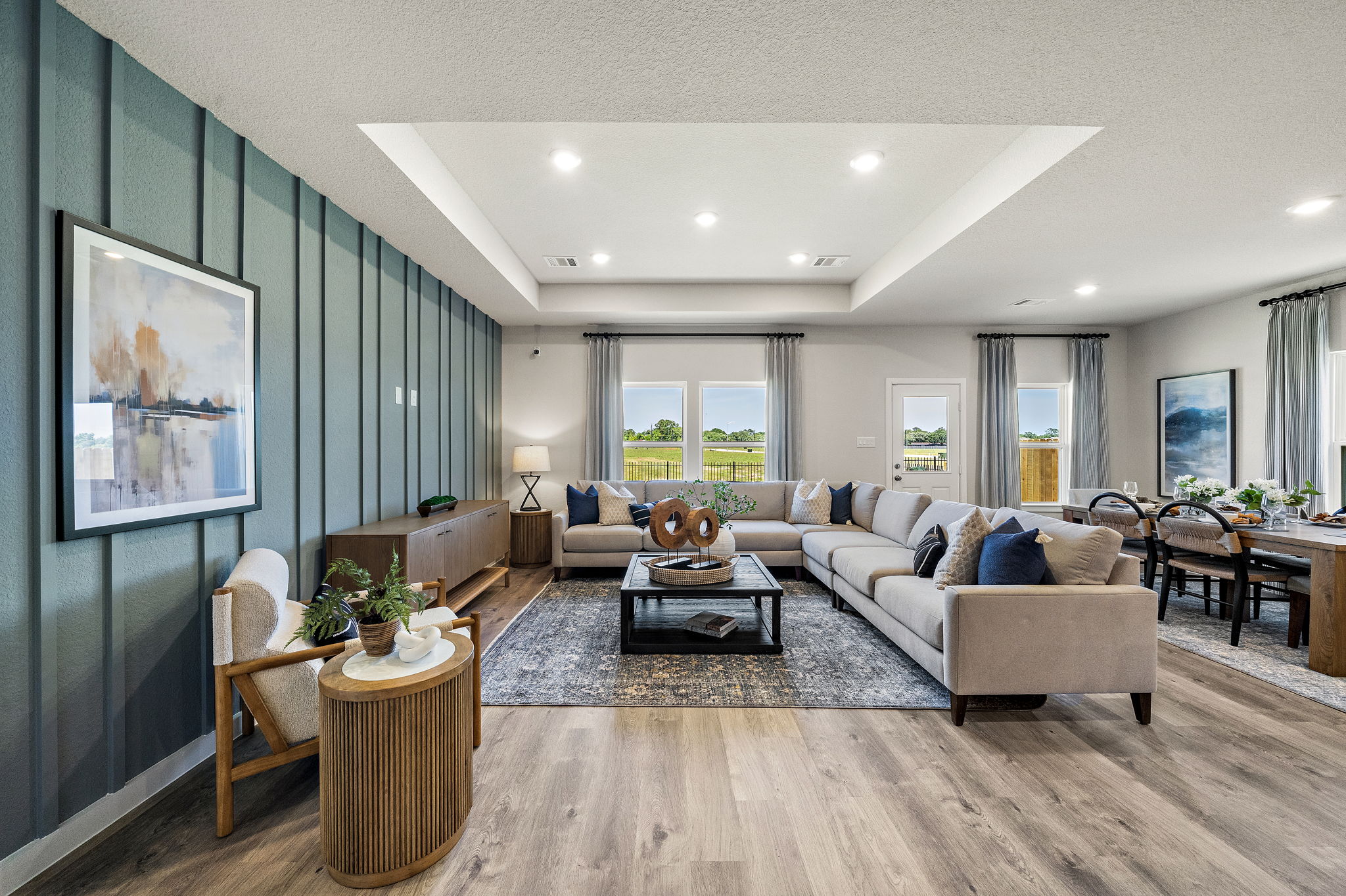 A living room with a large rug and a large window.