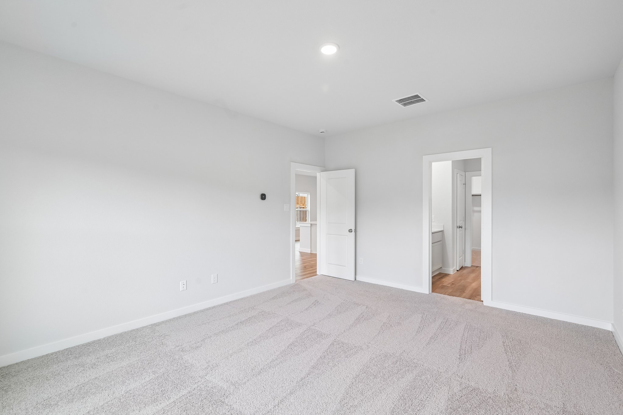 A hallway with white walls.