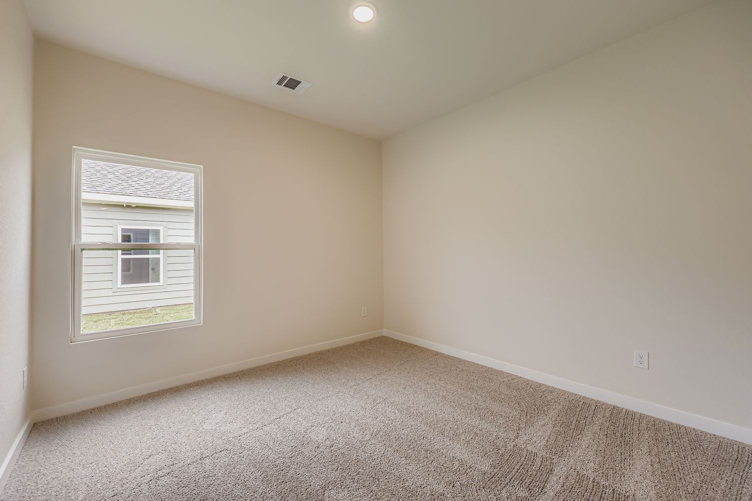 A room with a window and carpet.