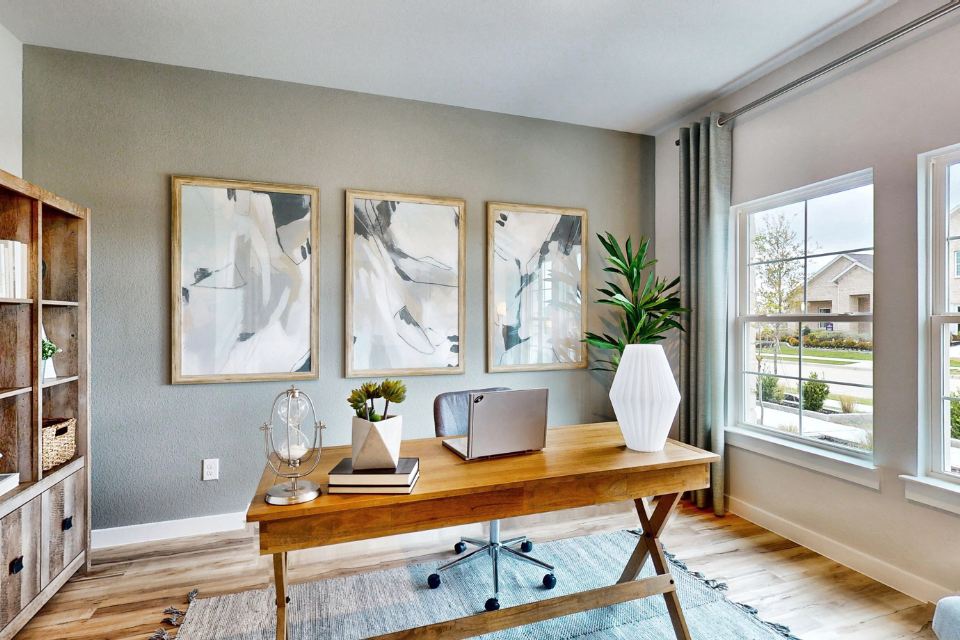 A room with a desk and a television.