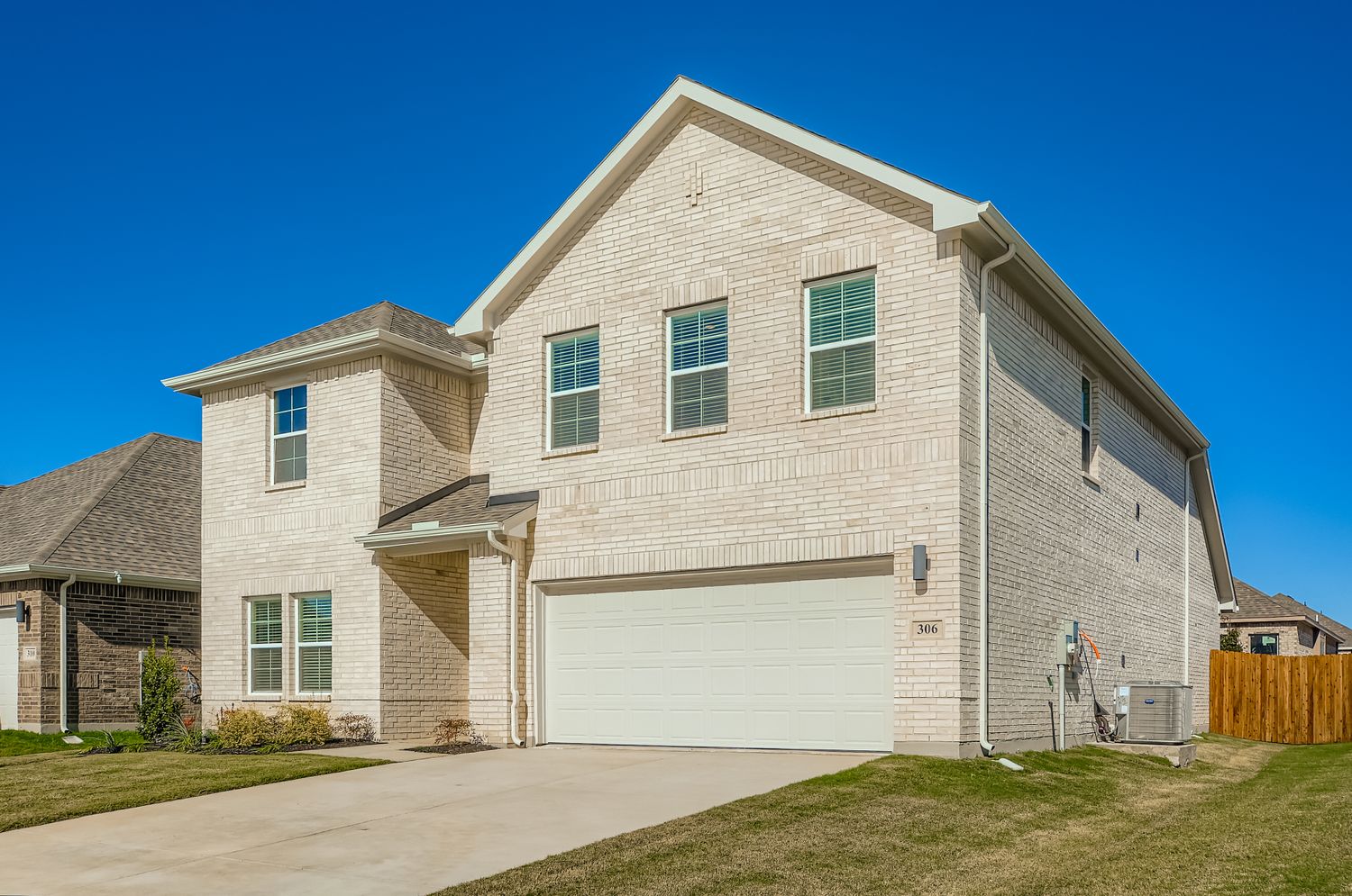 A house with a garage with Rockingham Meeting House in the background.