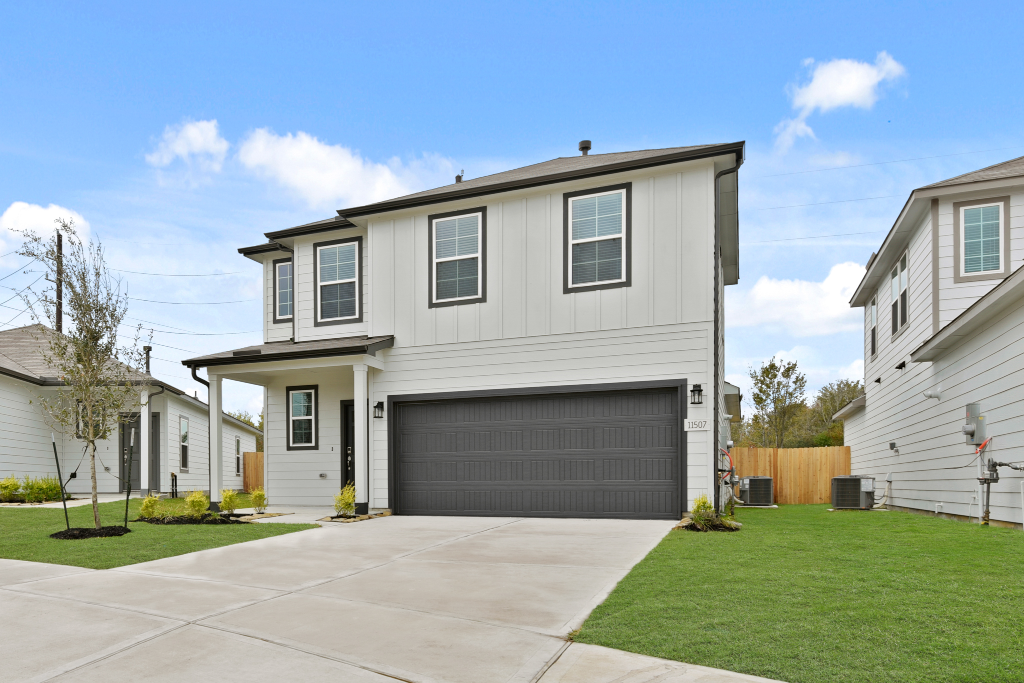 A white house with a garage.
