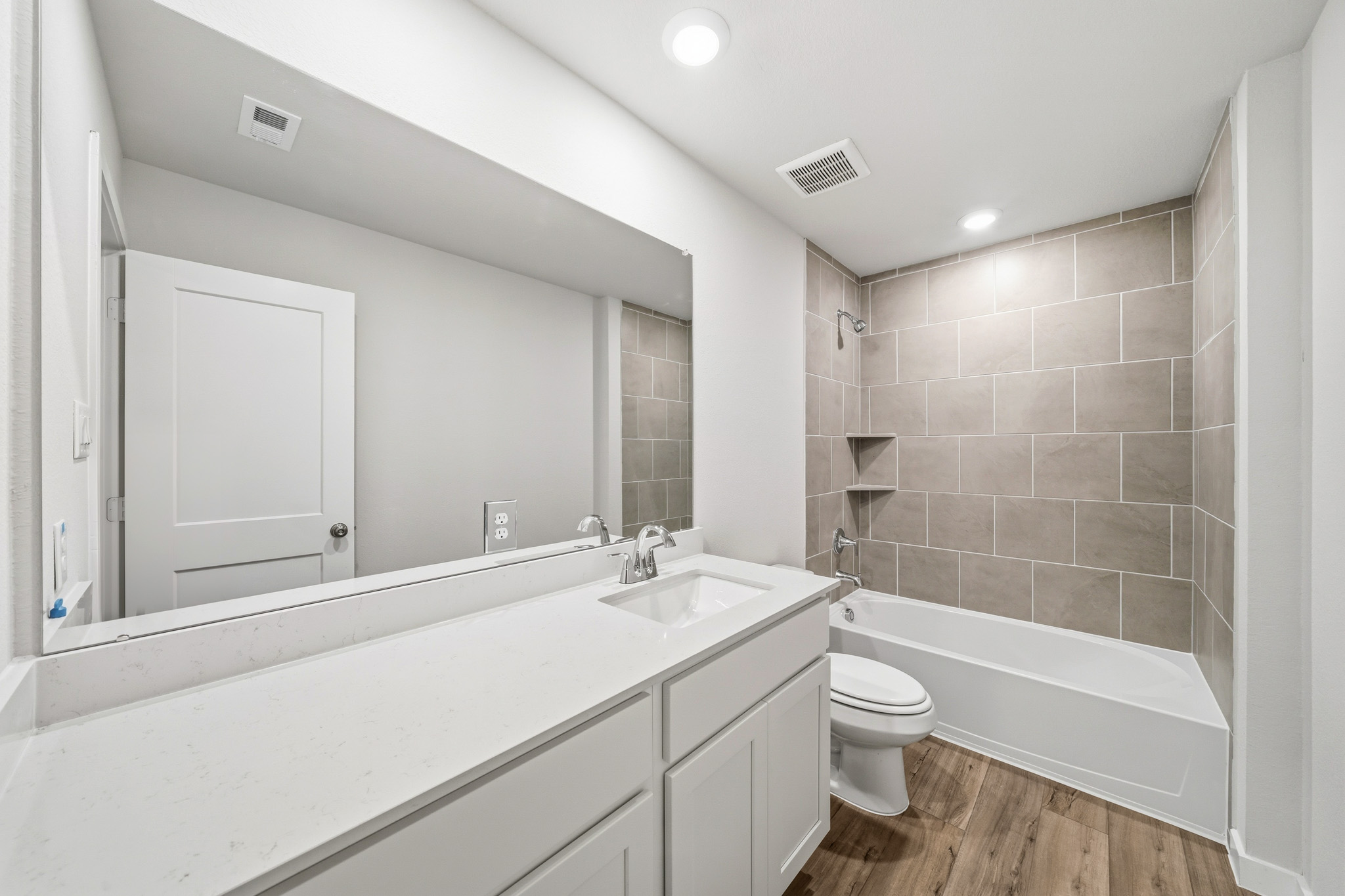 A bathroom with a tub sink and toilet.