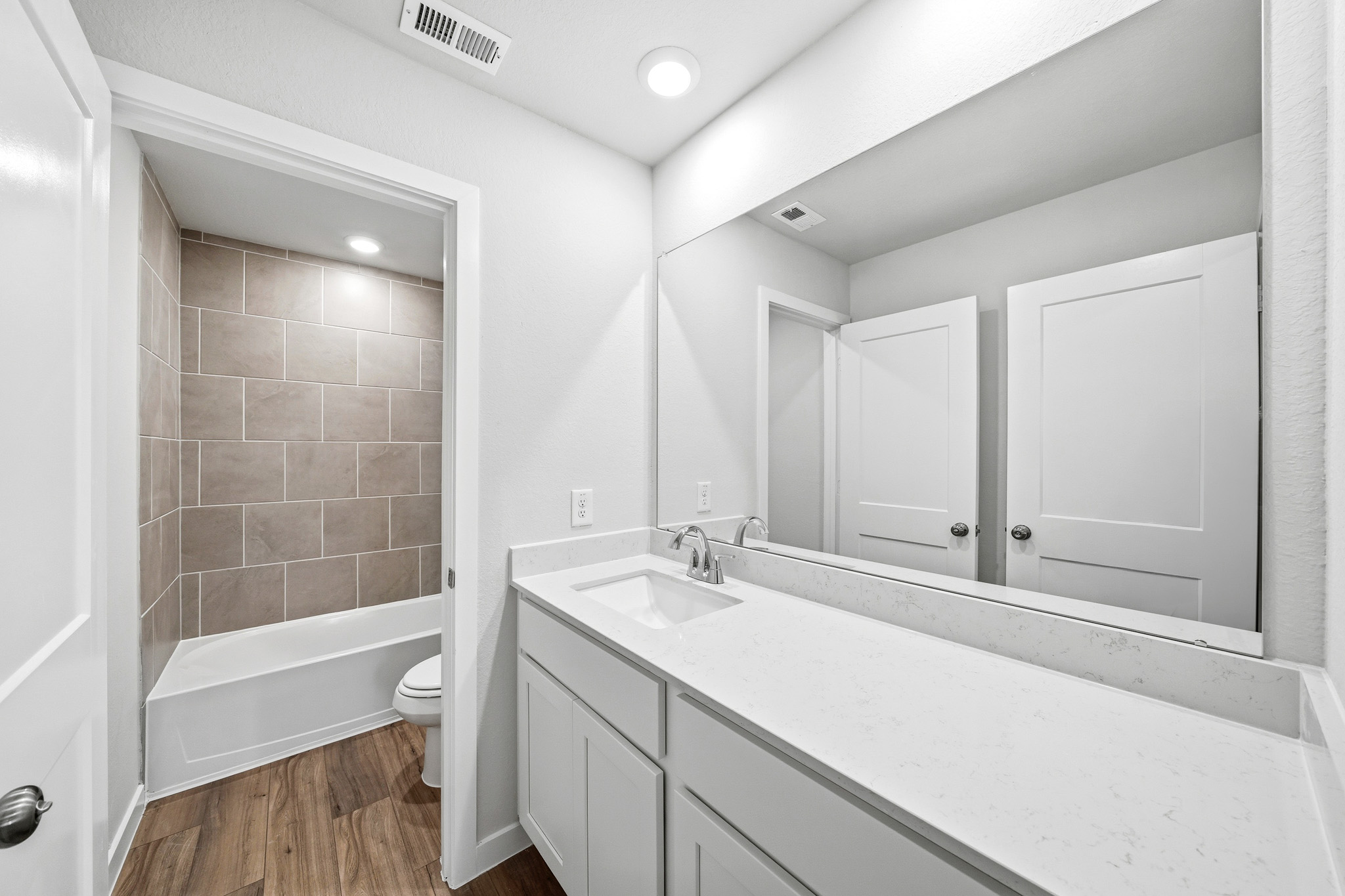 A bathroom with a tub sink and toilet.