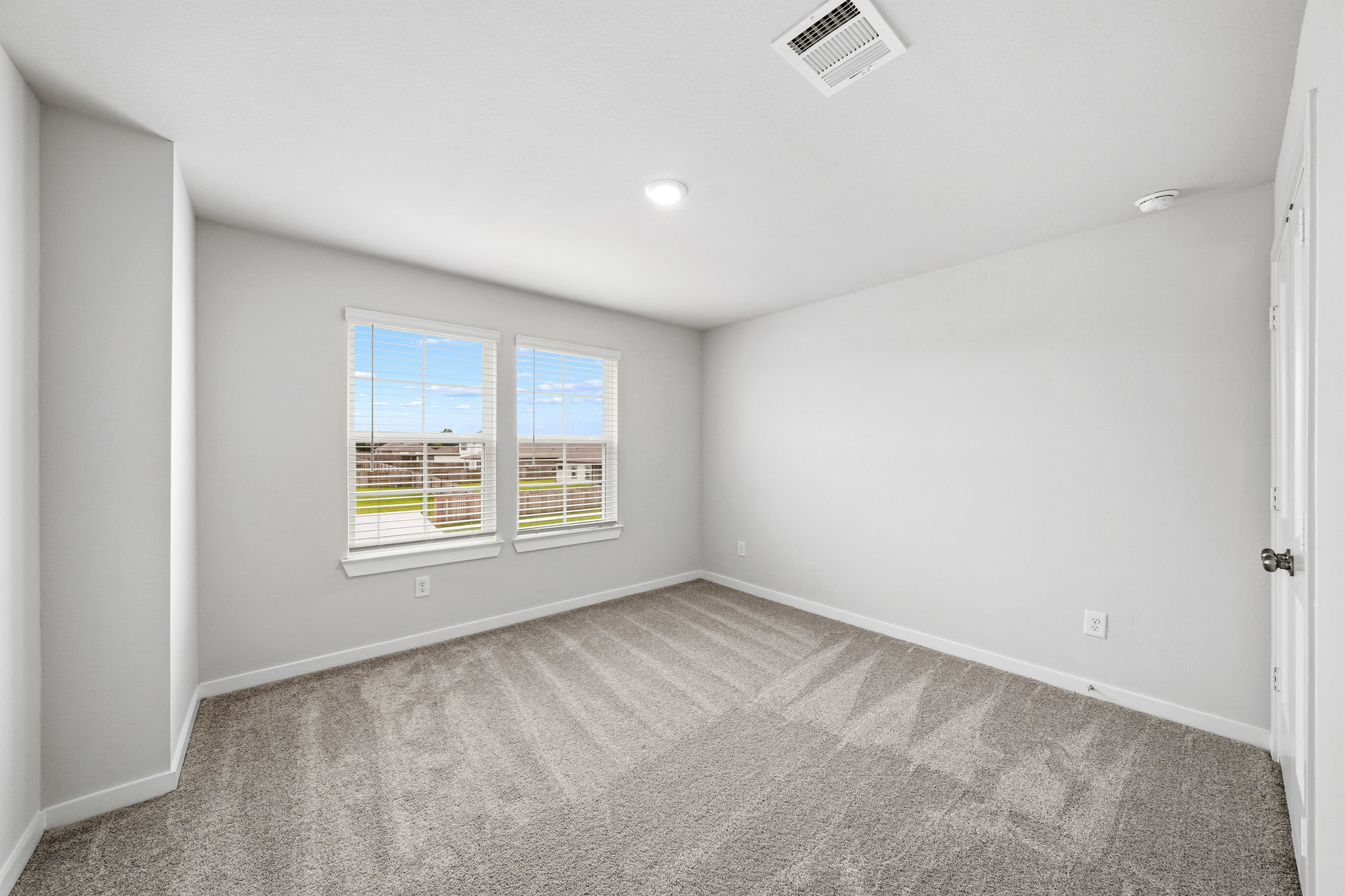 A room with a window and a door.