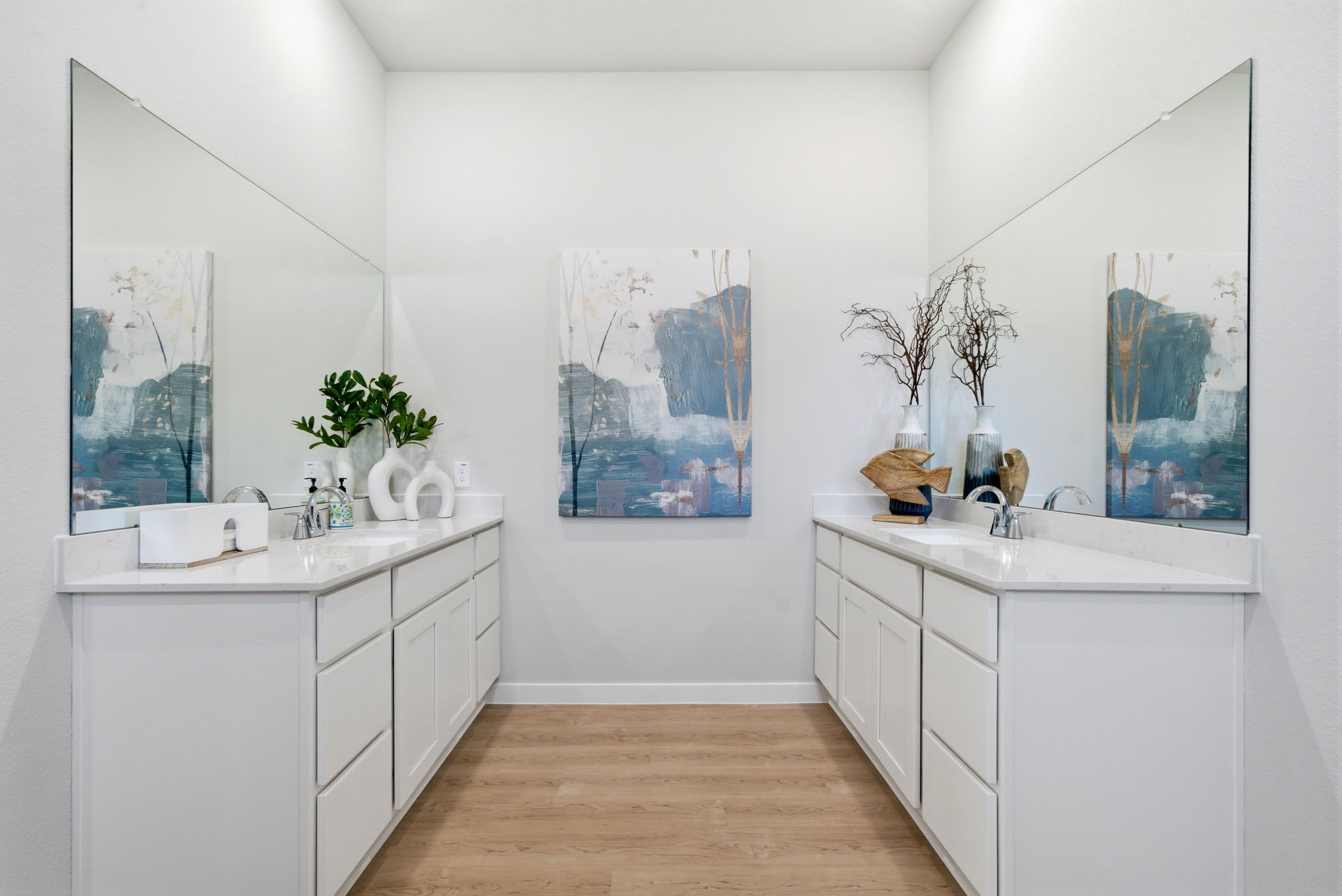A bathroom with white cabinets.