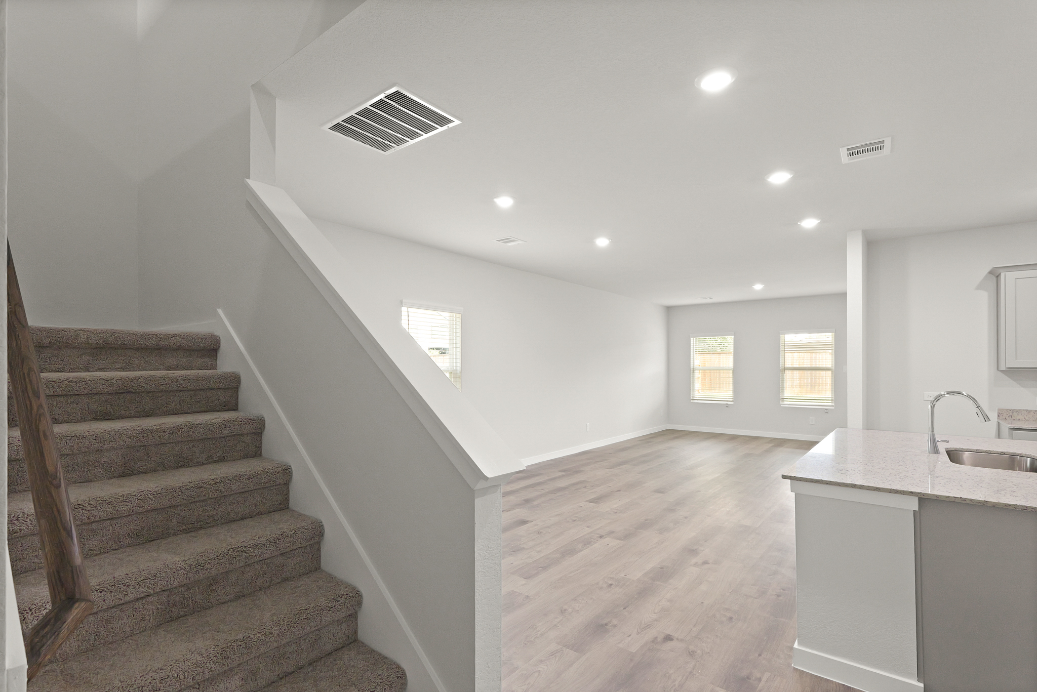 A large bathroom with a staircase.