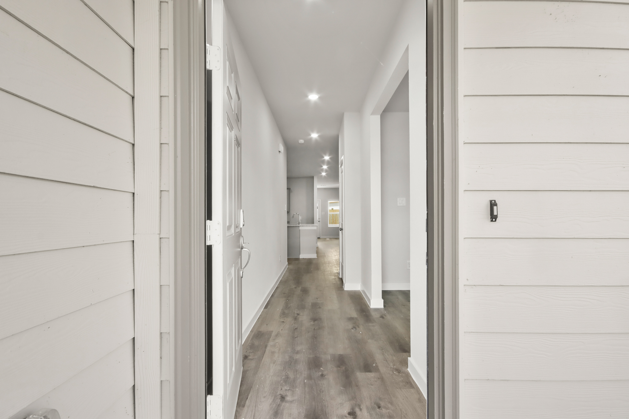 A hallway with white walls.