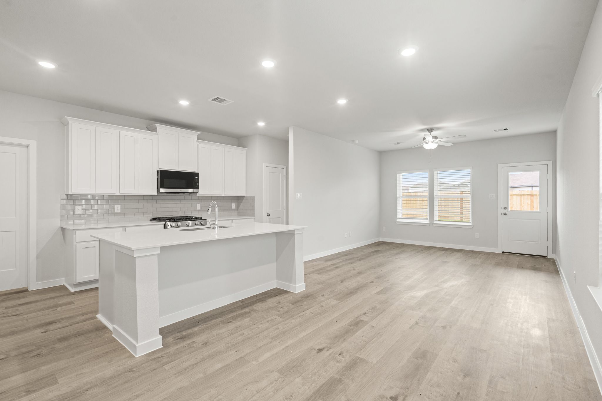 A kitchen with white cabinets.