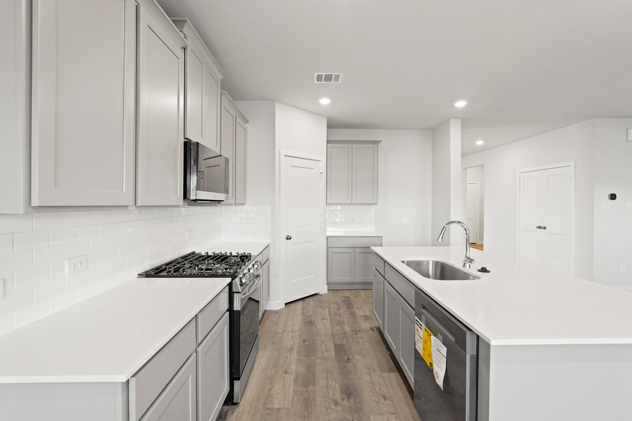 A kitchen with white cabinets.